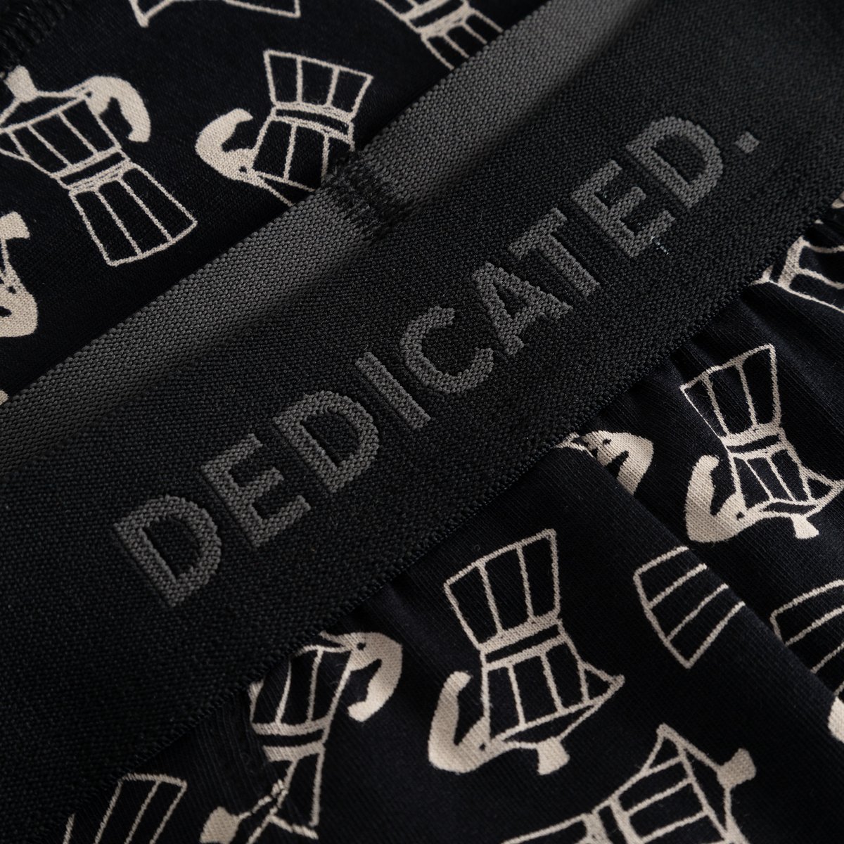 Detail shot of Kalix Mocca Boxer Briefs, highlighting the black-on-black Dedicated logo on the waistband and Moka pot print.