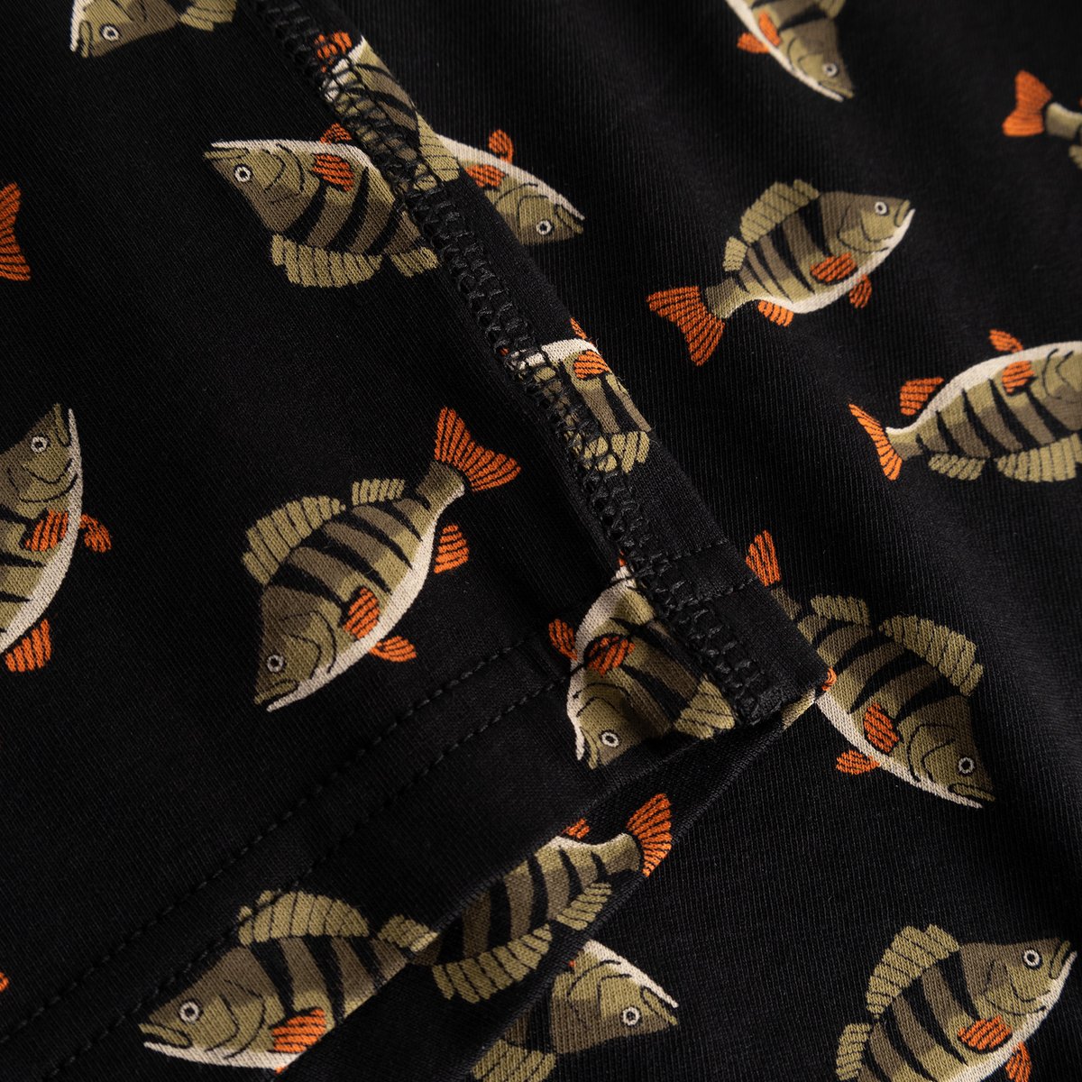 A fun all-over perch print covers the soft black fabric of these Kalix boxer briefs, shown here in a detailed close-up.
