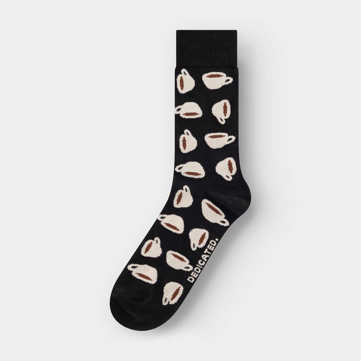 Studio shot of a single black sock with a fun all-over pattern of coffee cups against a grey background.