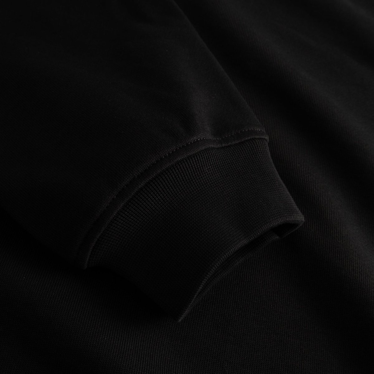 Close-up of the ribbed cuff on the sleeve of the black Sweatshirt Ystad Autumn Harvest.
