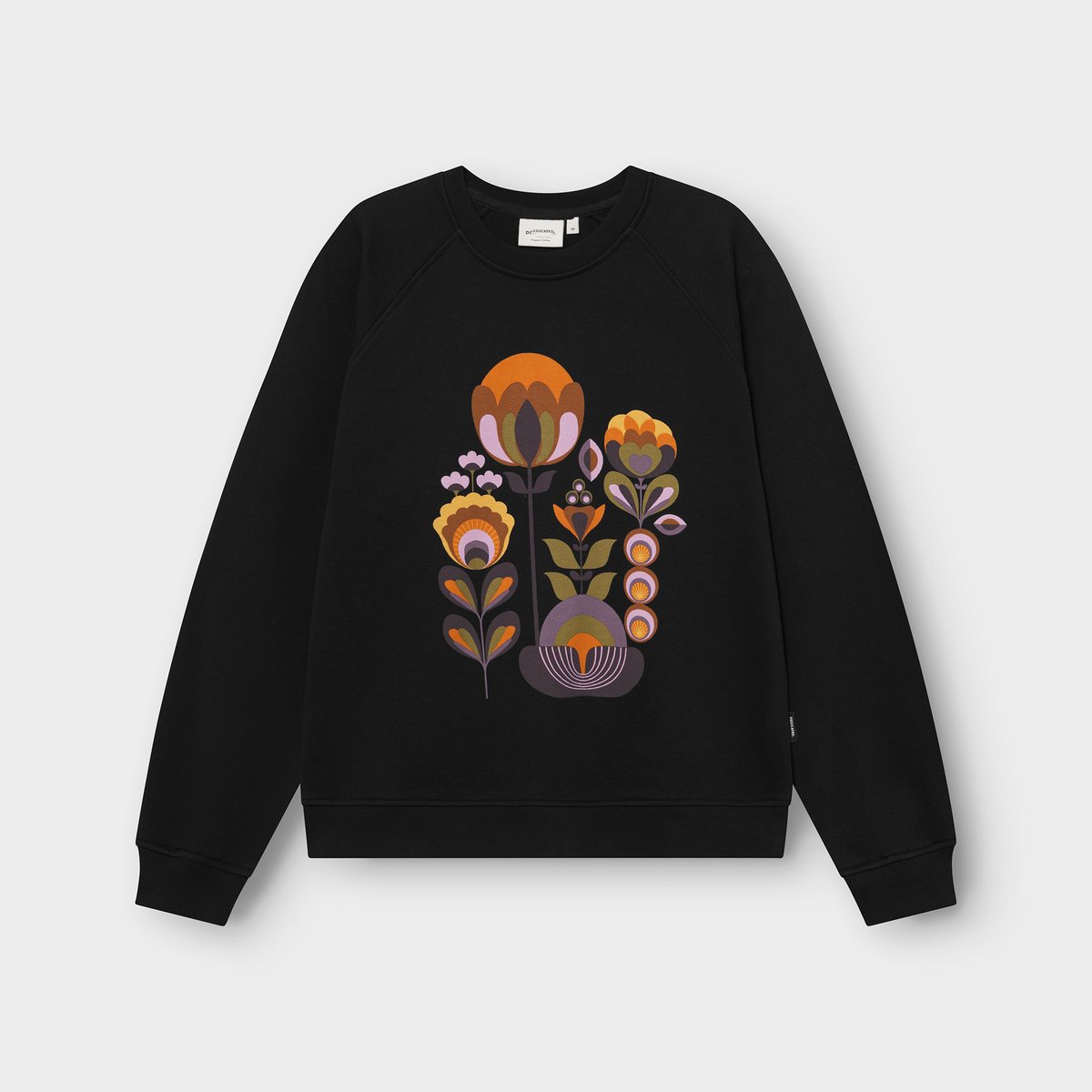 A flat lay of the black Sweatshirt Ystad Autumn Harvest, featuring a stylized floral graphic in warm, autumnal colors.