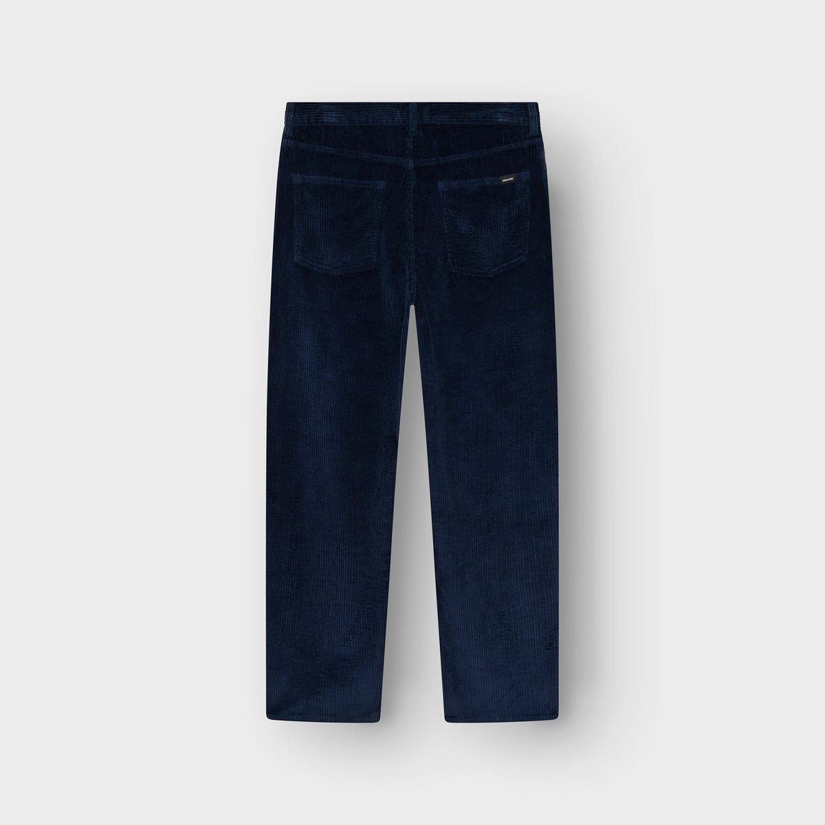 Back view of the relaxed-fit Hamburg corduroy pants in navy, laid flat against a light grey background.