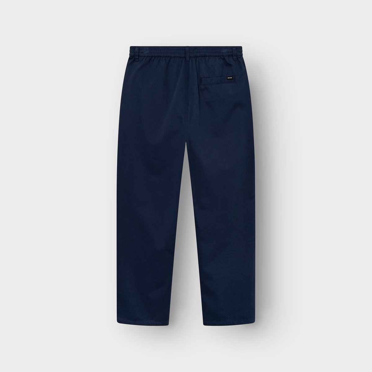Back view of the navy Hudiksvall chino pants, laid flat to show the elasticated waistband and back pocket detail.