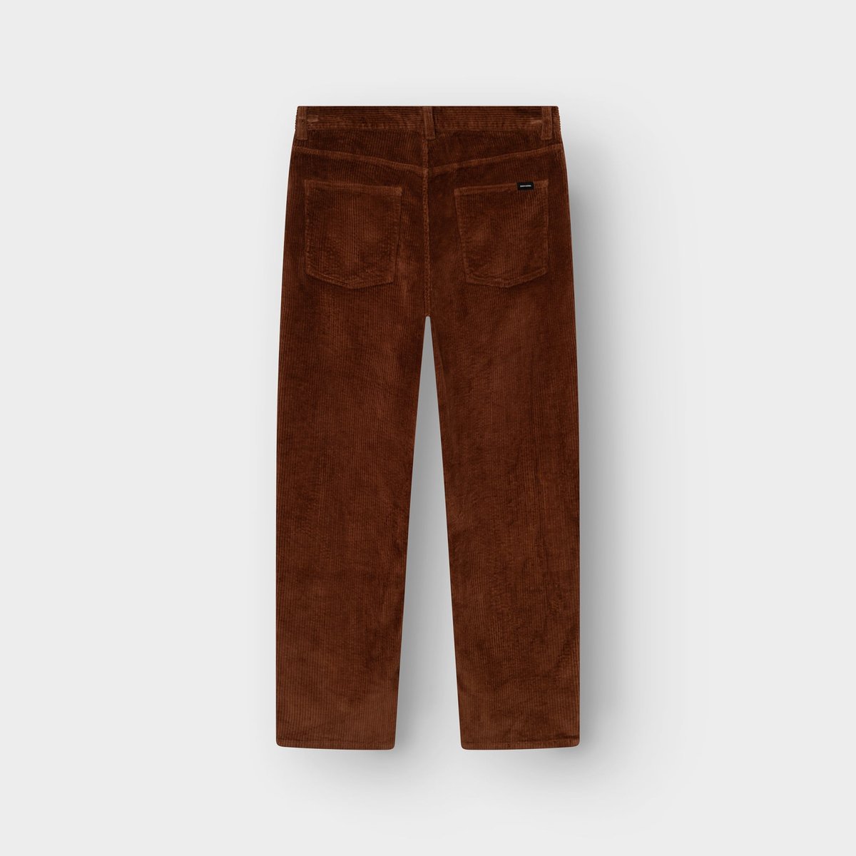 A back view of the Pants Hamburg Corduroy in Cappuccino Brown, highlighting its relaxed fit and retro texture.