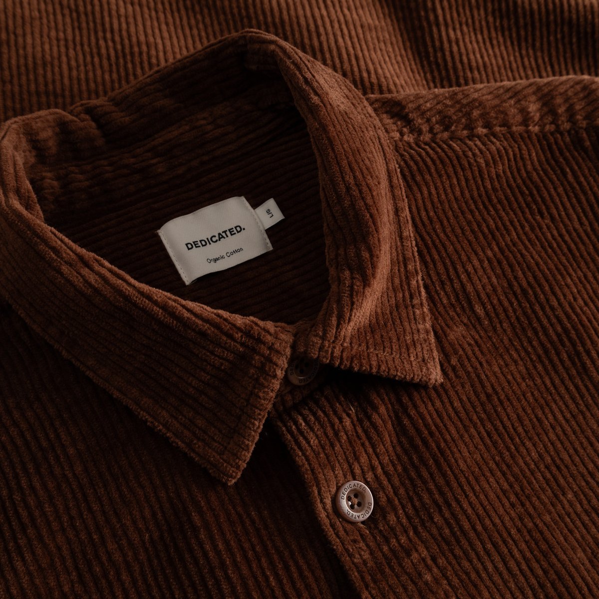 Detailed close-up of the Shirt Kil Corduroy in Cappuccino Brown, showcasing the fabric's texture and collar's brand label.