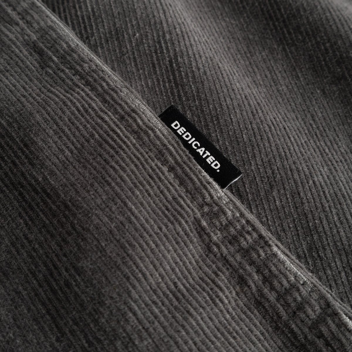 A close-up of the Shirt Varberg Corduroy in Rock Grey, showing the fabric's soft texture and the stitched Dedicated label.