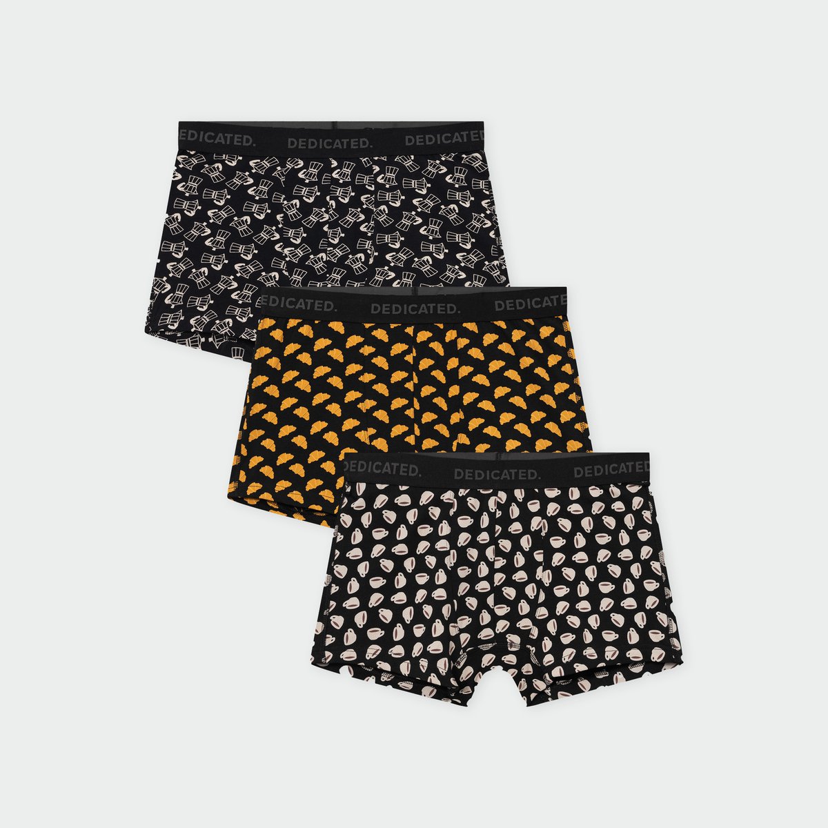 A 3-pack of Dedicated's Kalix boxer briefs in fun breakfast-themed prints, including croissants and coffee cups.