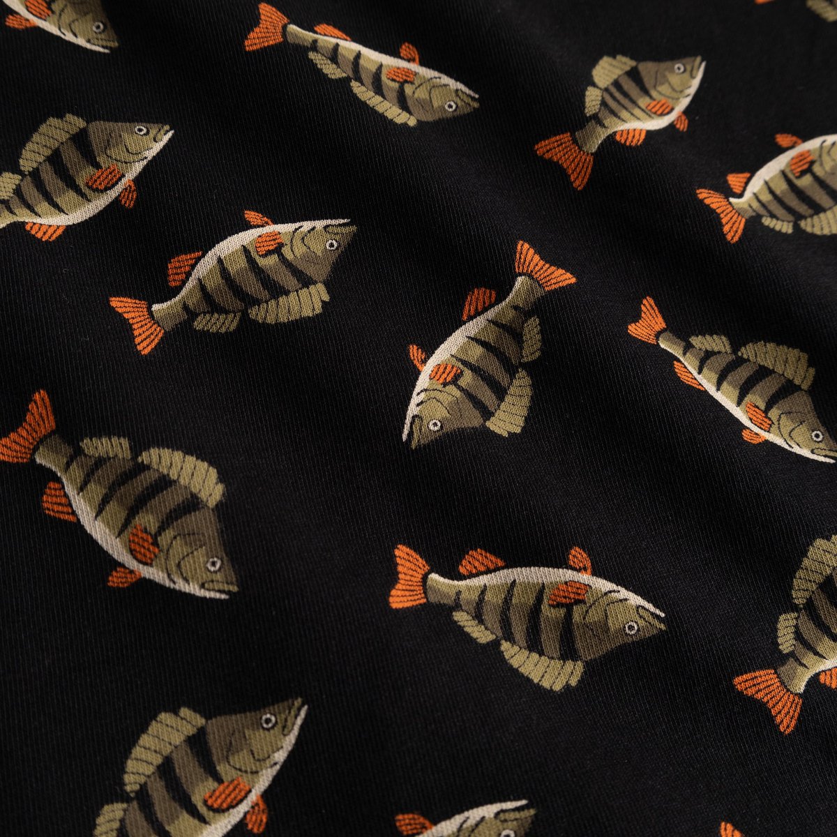 Close-up shot of the black fabric on the Kalix boxer briefs, showing the all-over fish pattern.