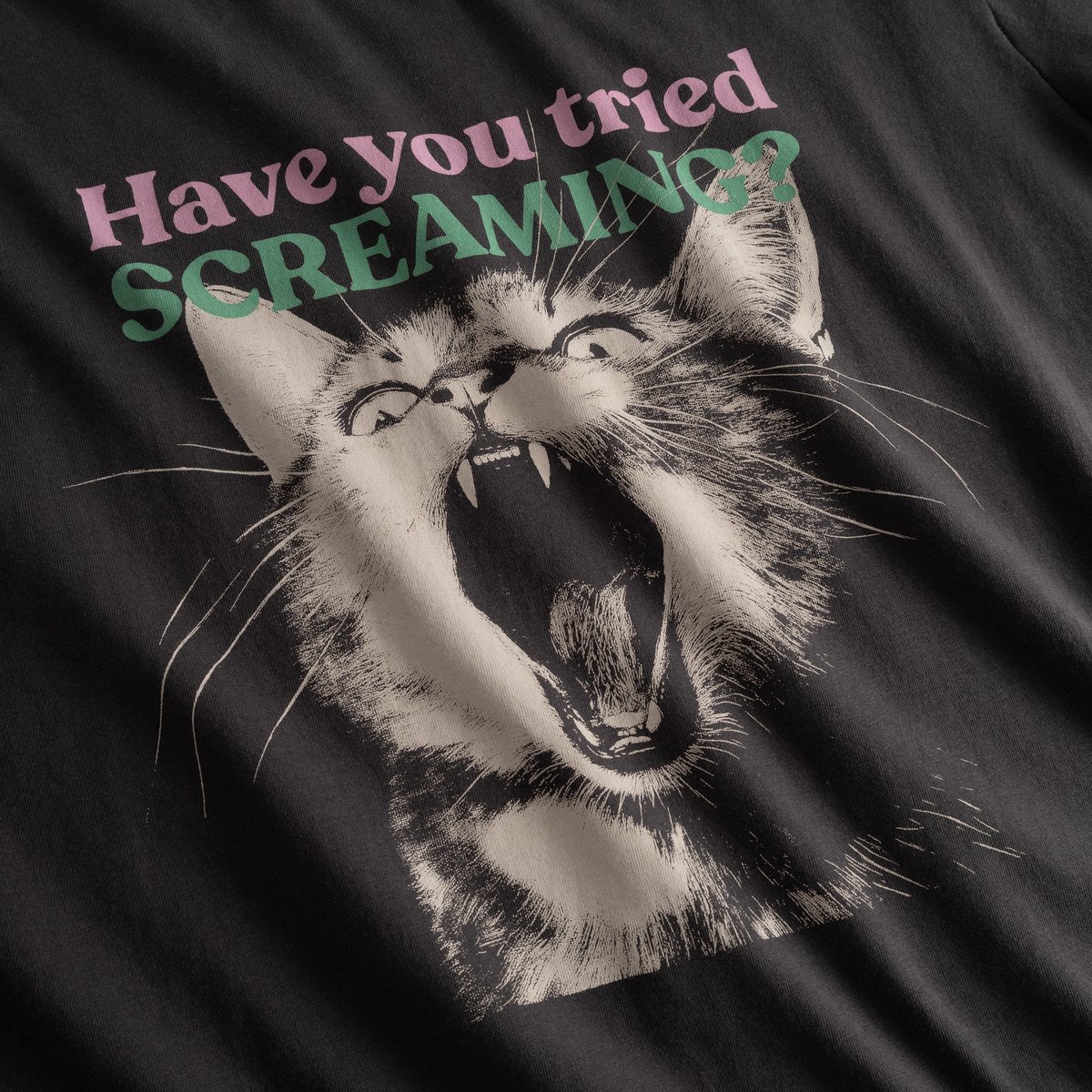 A close-up of the charcoal t-shirt's 'Screaming Cat' graphic, which asks 'Have you tried SCREAMING?'.
