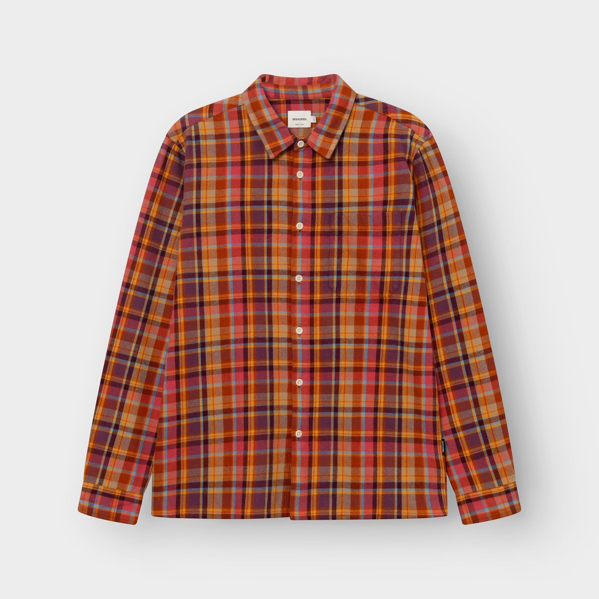 Front view of the Rute flannel shirt in a warm madras check of red, orange, and blue, laid flat on a light background.