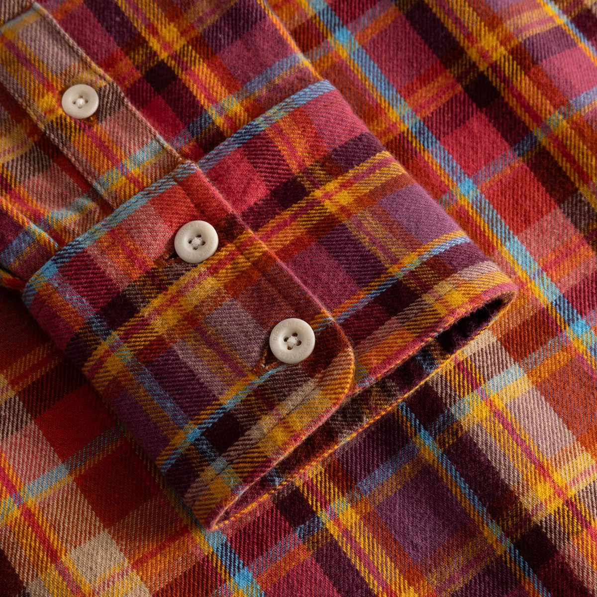 A close-up of the Arboga shirt's cuff, detailing the soft, brushed flannel in a multi-color madras check pattern.