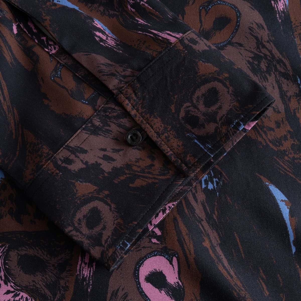 Detail shot of the wide cuff on the Top Udda Owls, showcasing the expressive brushstroke pattern and single button closure.