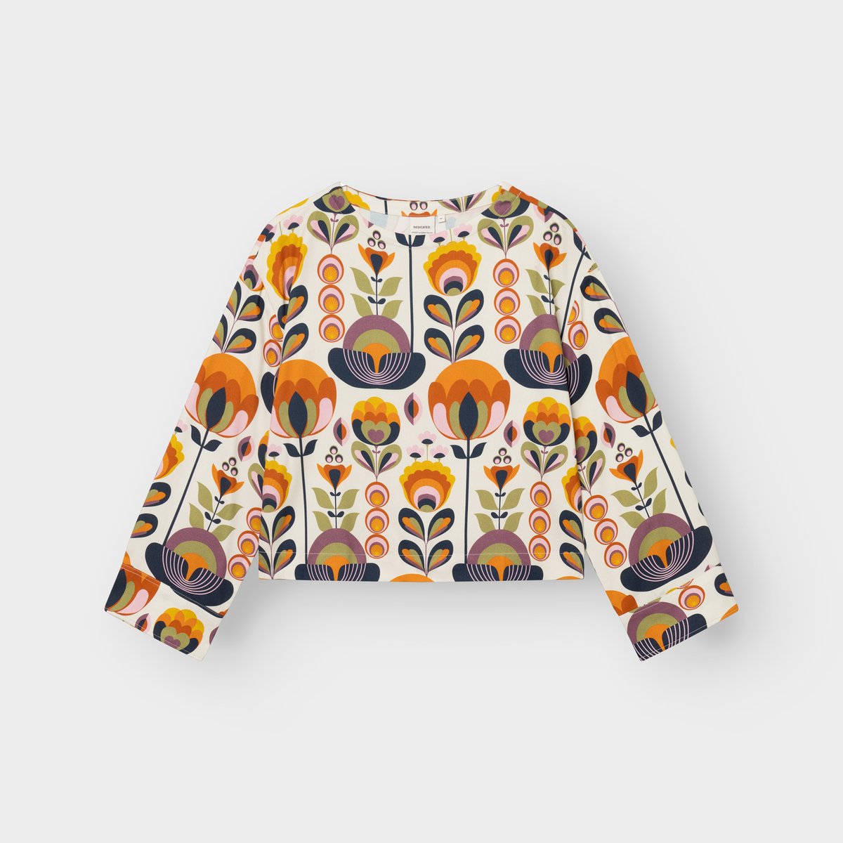 Studio shot of the Top Udda in the vibrant Autumn Harvest print, featuring a boxy fit and wide, long sleeves.