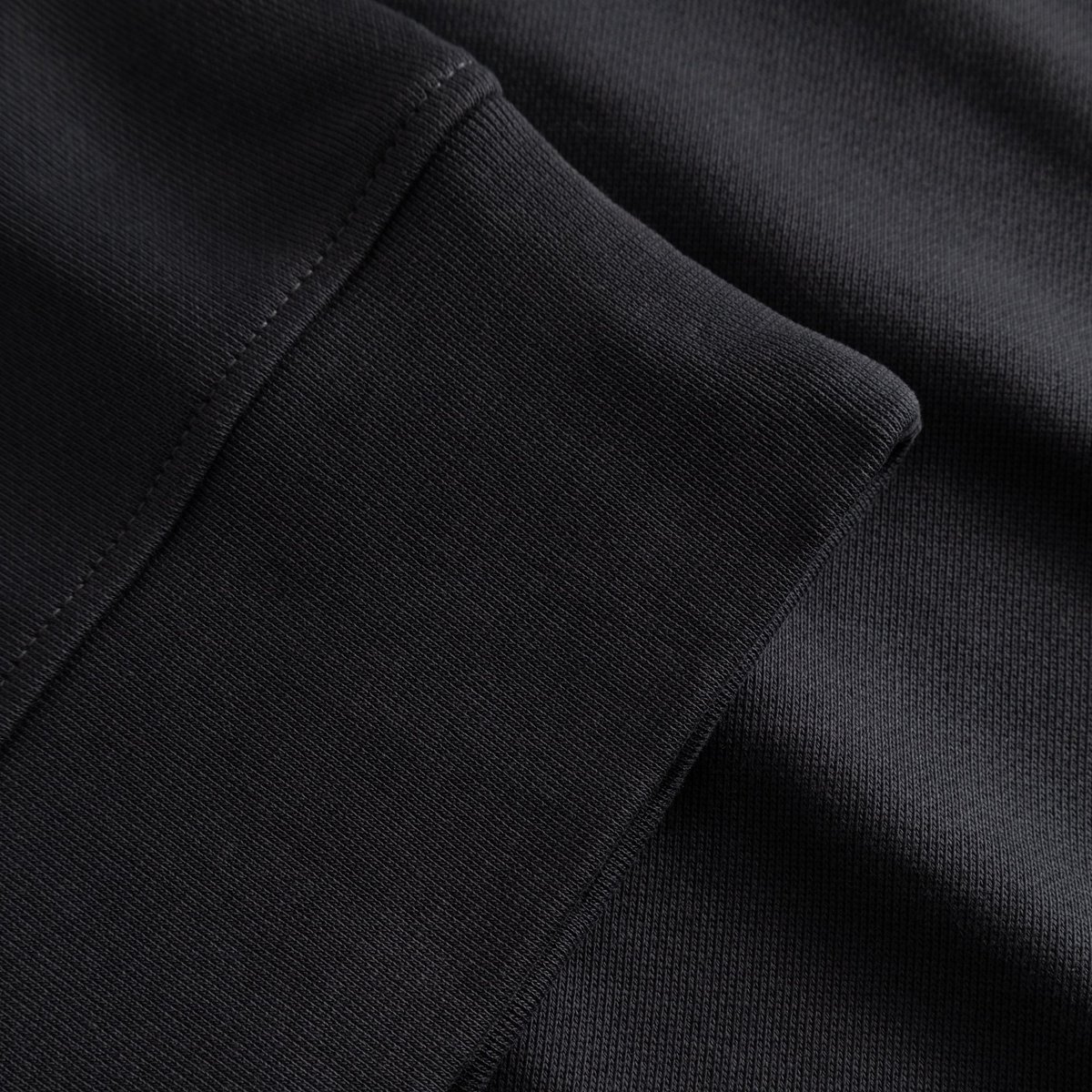 Close-up of the ribbed cuff and heavy cotton fabric of the Sandvalla Half Zip Sweatshirt in Phantom Black.