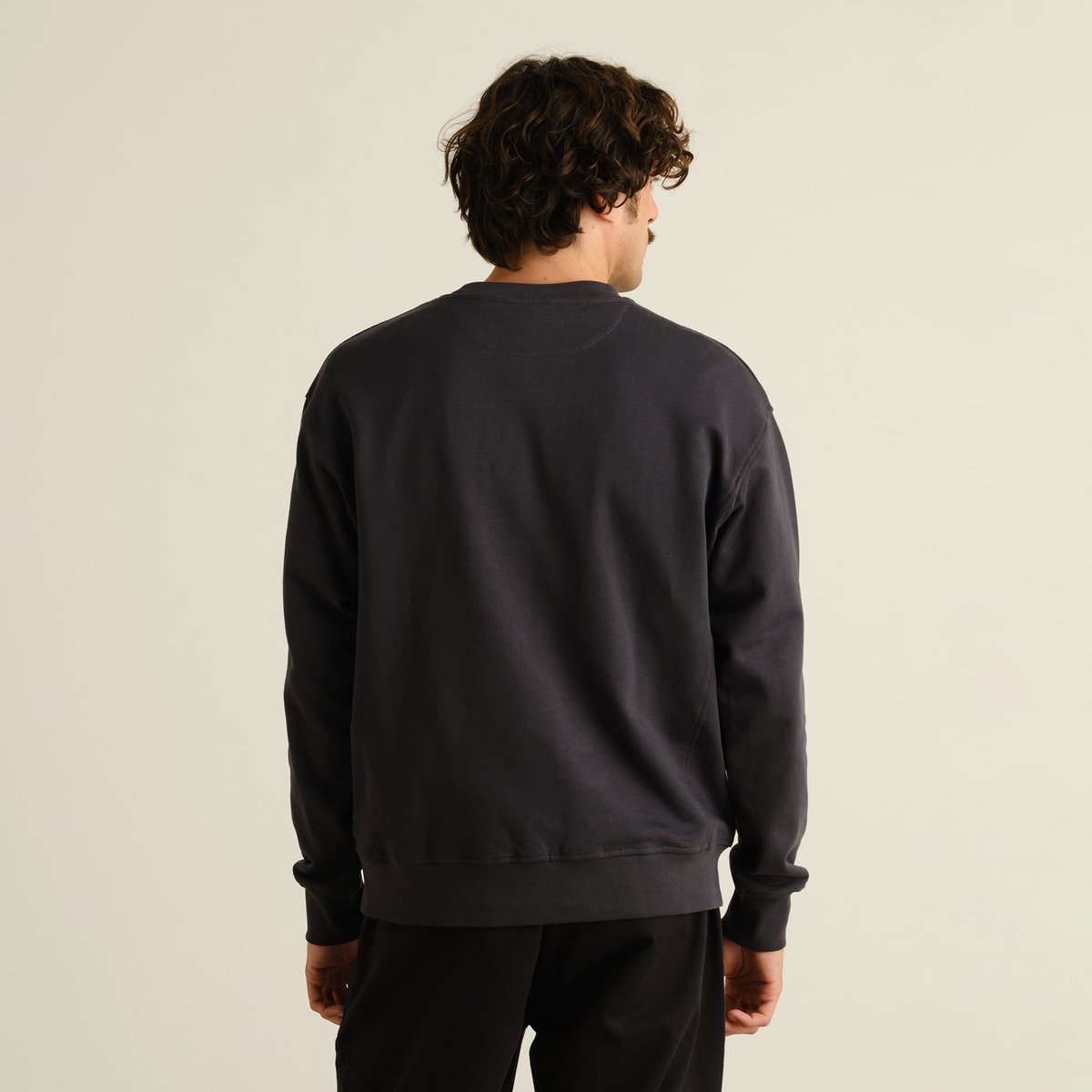 The Sweatshirt Bettna in Phantom Black, showing off its clean lines and relaxed fit from the back.