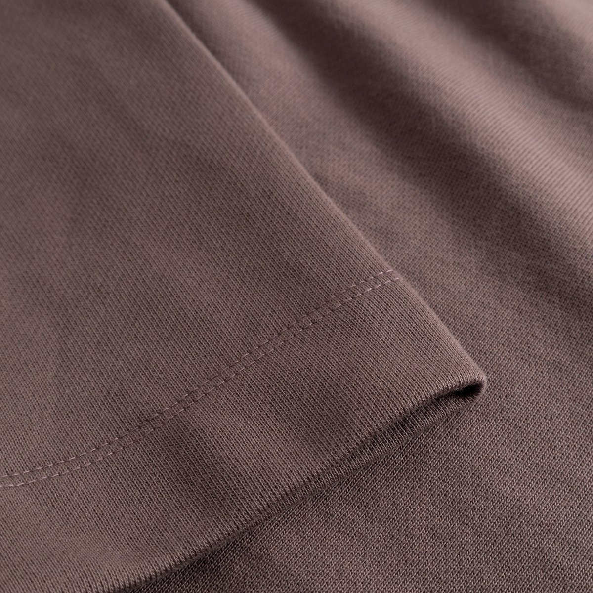 A close-up shot of the rich Sparrow Brown fabric and neat cuff detail on the Gia sweatshirt.