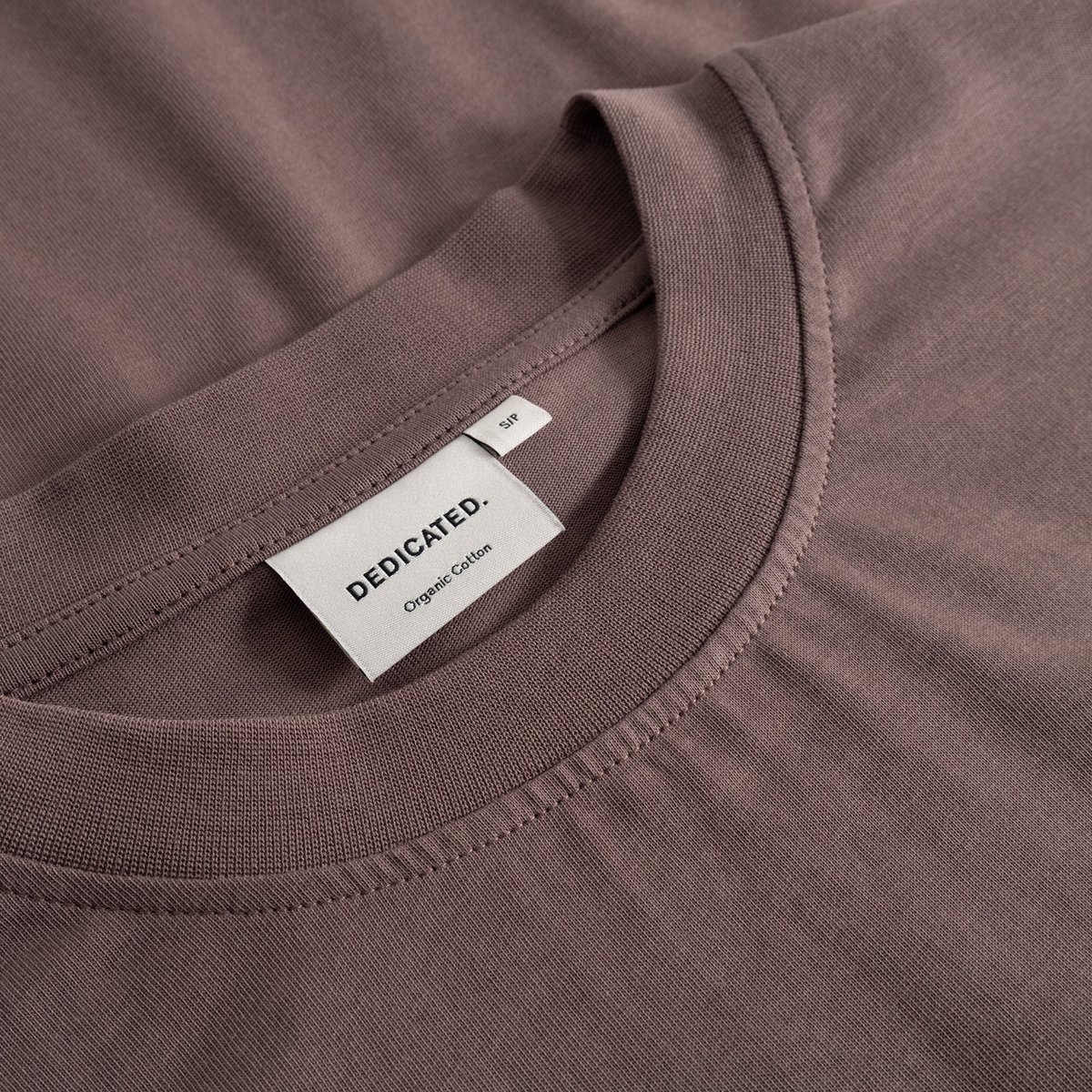 Close-up of the Dedicated Vreta T-shirt in Sparrow Brown, showing the finely ribbed collar and soft organic cotton fabric.
