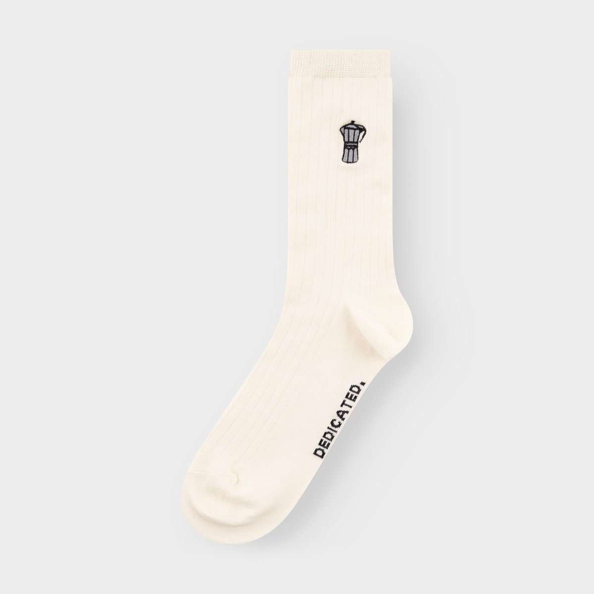 Studio shot of the off-white Knivsta sock by Dedicated, featuring a fun embroidered moka pot on the ankle.