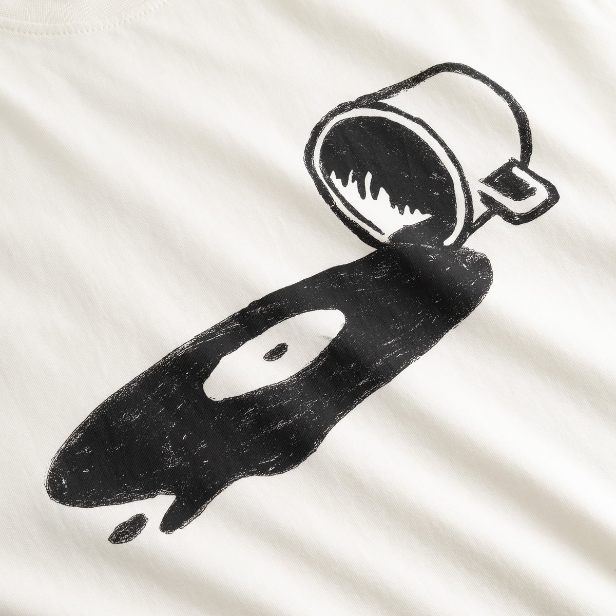Close-up on the chest of the off-white T-shirt Stockholm Spilled, showing the quirky spilled coffee and vinyl record graphic.