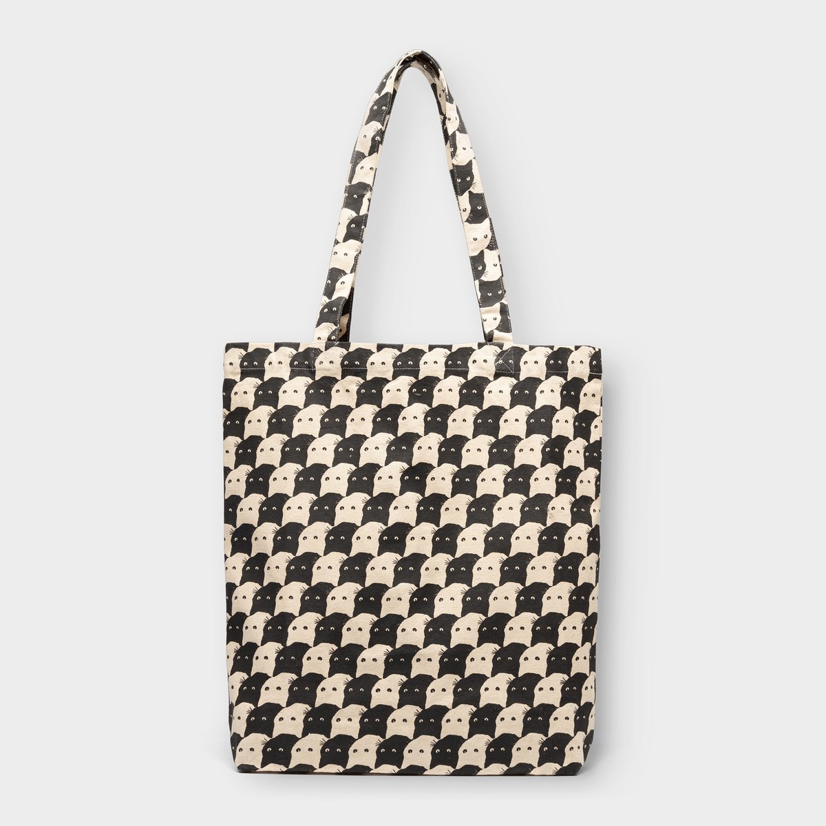 Studio shot of the Tote Bag Torekov in off-white, featuring a graphic all-over print of black and white cat faces.