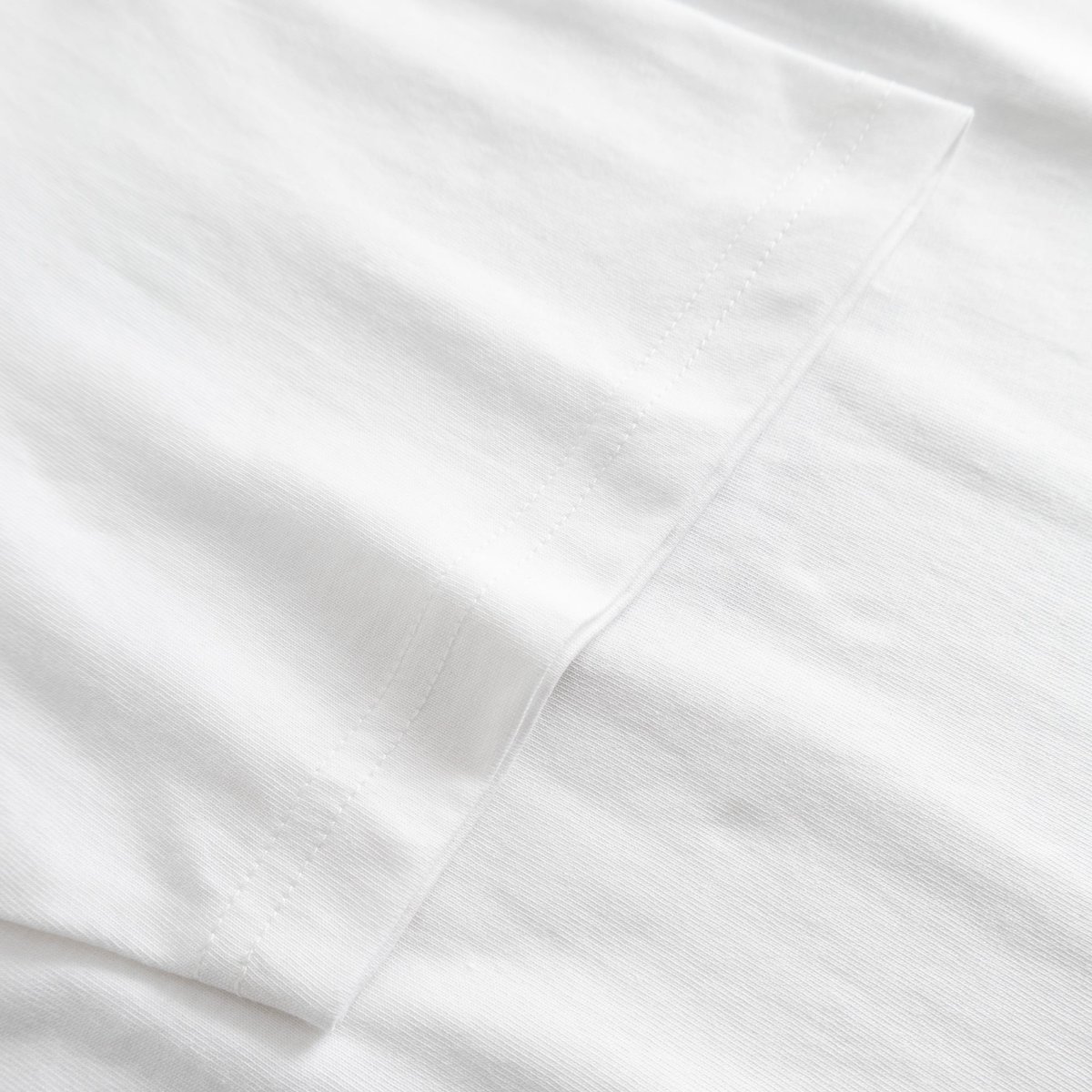 A close-up view showcasing the quality stitching and soft organic cotton fabric of the white Stockholm t-shirt.