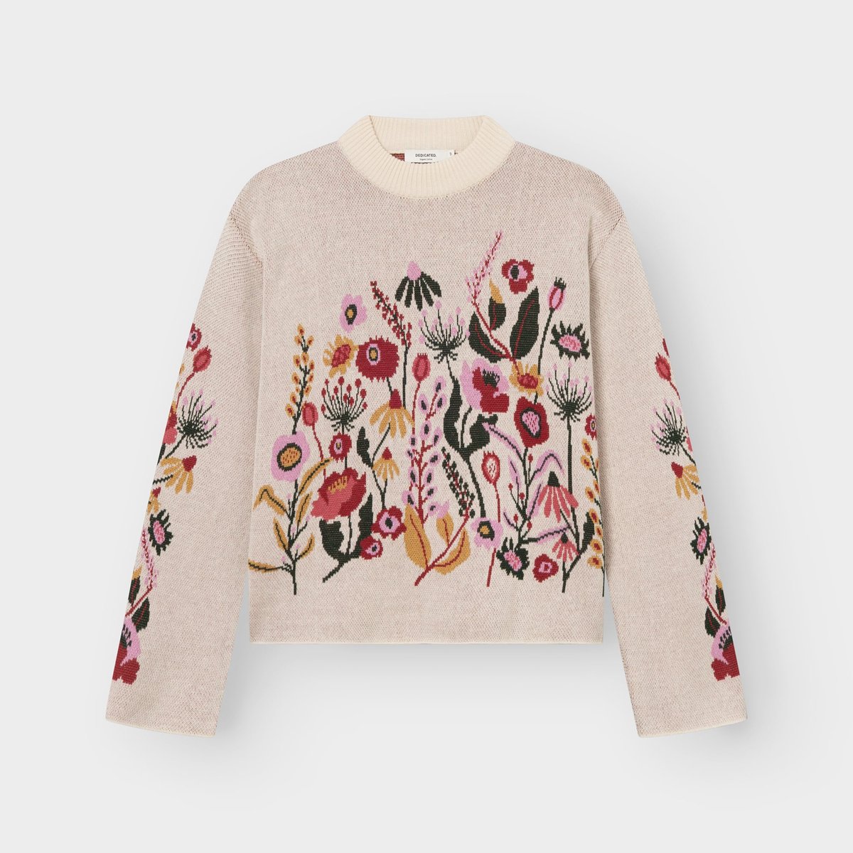 A flat lay of the vanilla white Limhamn sweater, featuring a beautiful jacquard knit pattern of colorful folk flowers.