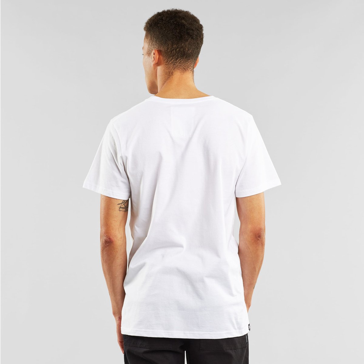 Back view of a model wearing the white T-shirt Stockholm Astrid och Duvan.