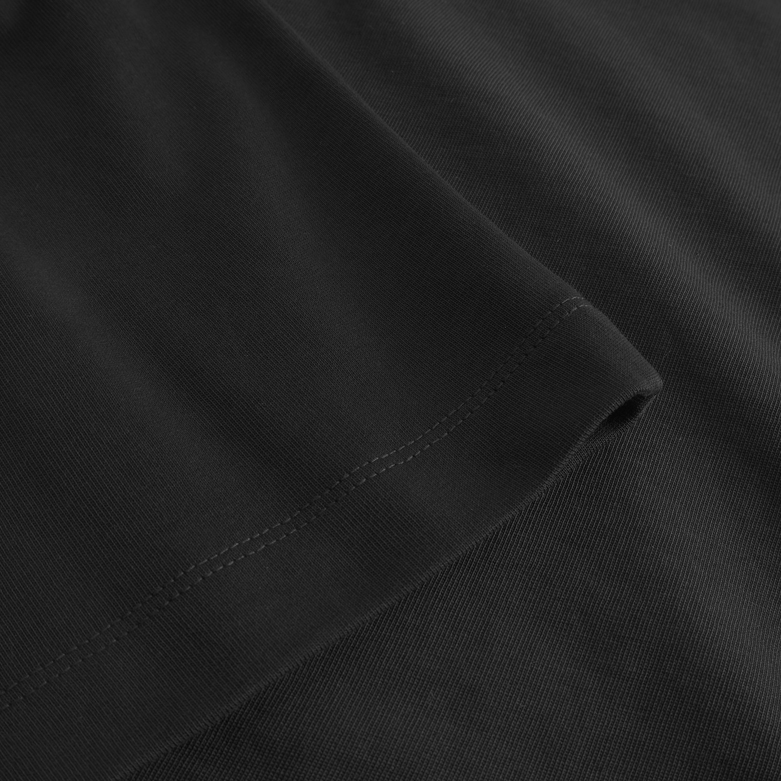 A close-up of the T-shirt Ljusdal in black, showing the detailed stitching on the sleeve and the quality of the fabric.