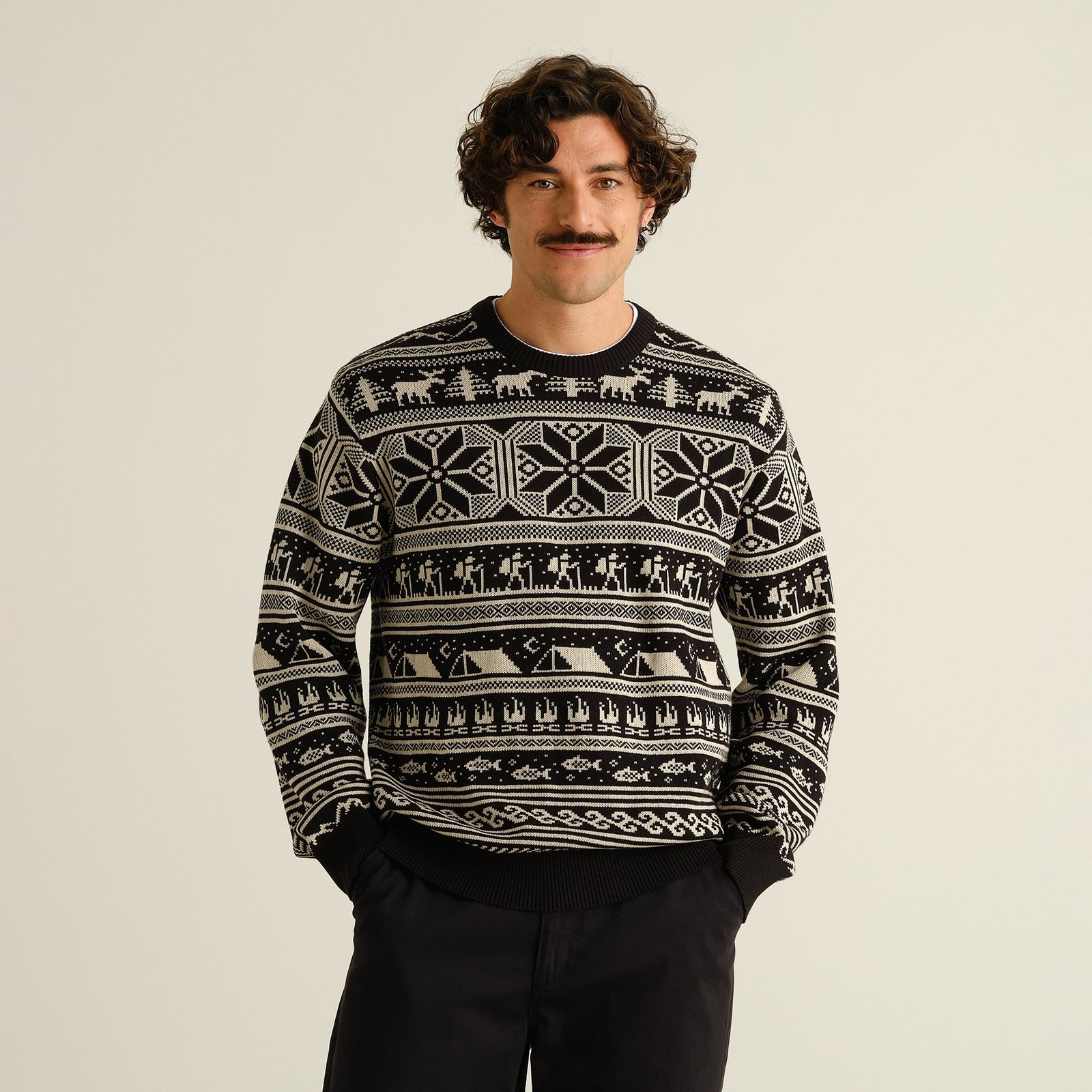 Front view of a man wearing the Sweater Mora Fairisle Hike in black, a patterned knit inspired by nature and the outdoors.