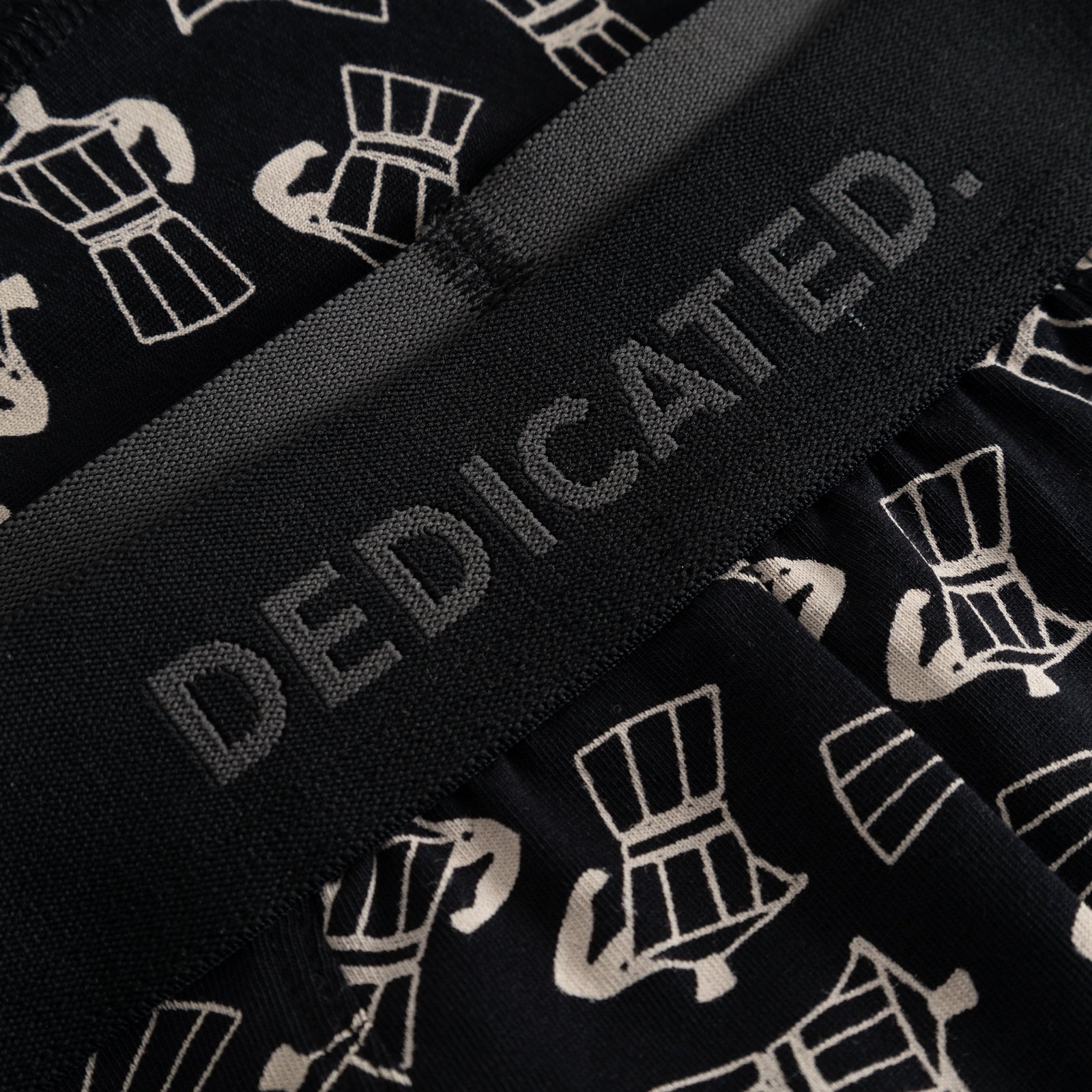 Detail shot of Kalix Mocca Boxer Briefs, highlighting the black-on-black Dedicated logo on the waistband and Moka pot print.