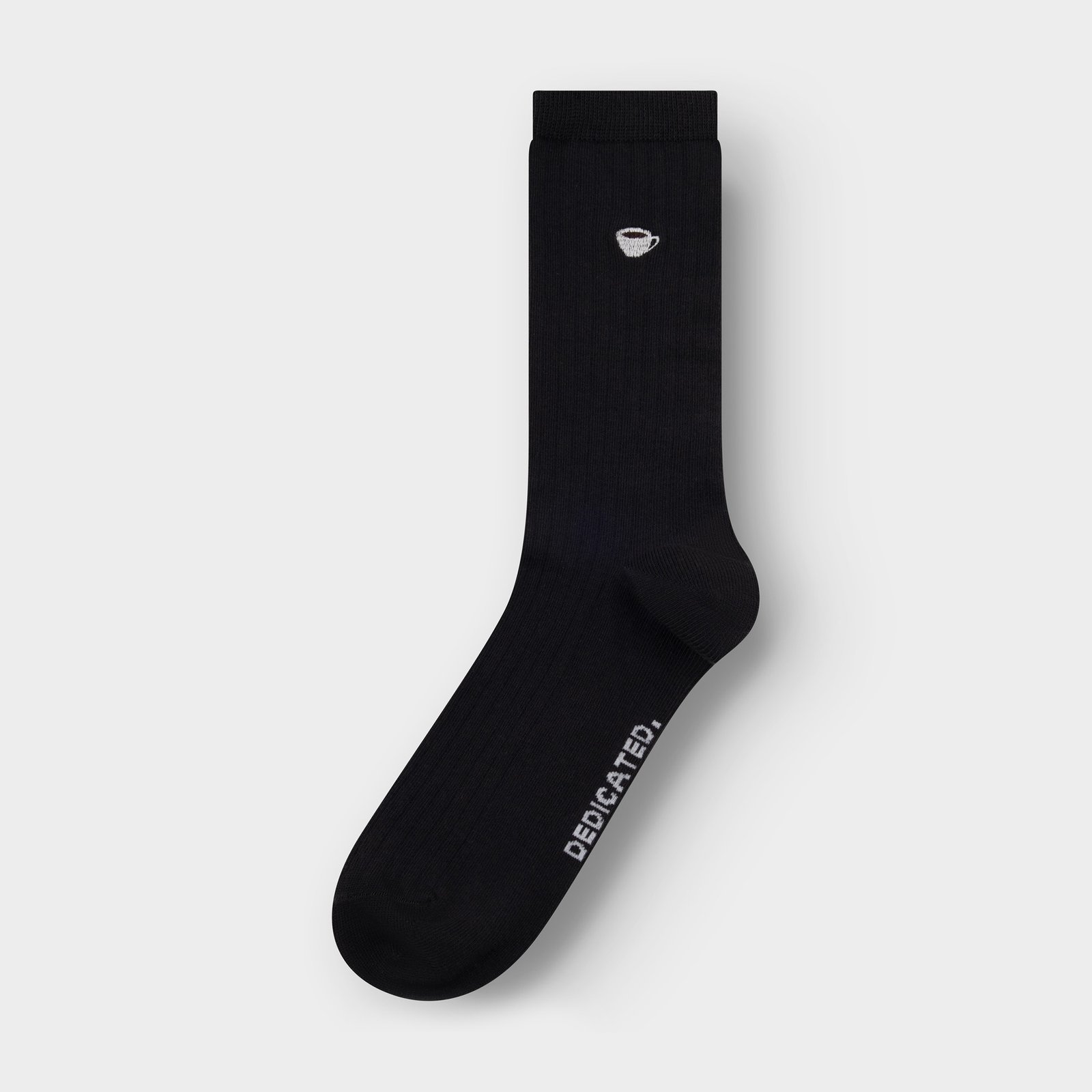 Studio photo of a single black ribbed sock from Dedicated, with a small coffee cup embroidered on the ankle.