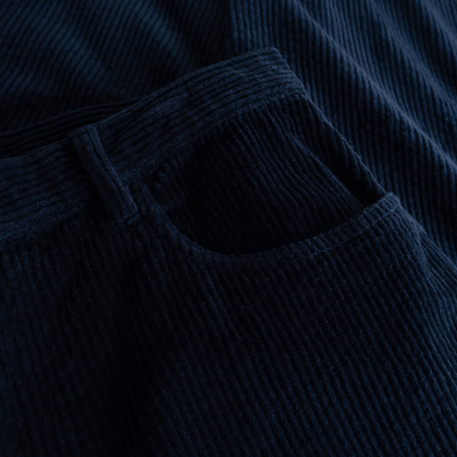 A close-up image showing the rich texture and deep navy colour of the corduroy fabric on the Pants Hamburg.