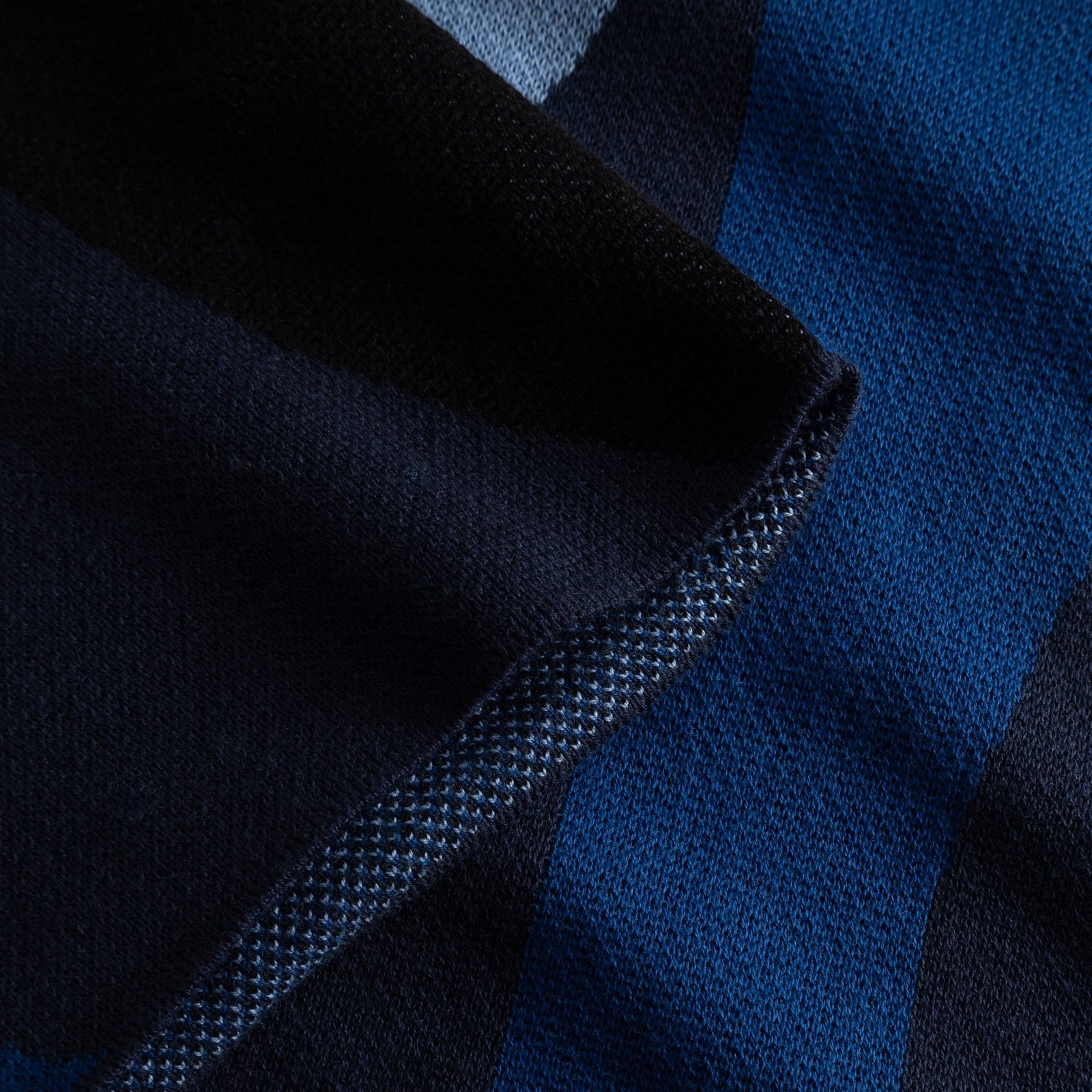 A close-up showing the soft texture and fine jacquard knit of the Dress Nikkala in its Wavy Stripe Blue pattern.