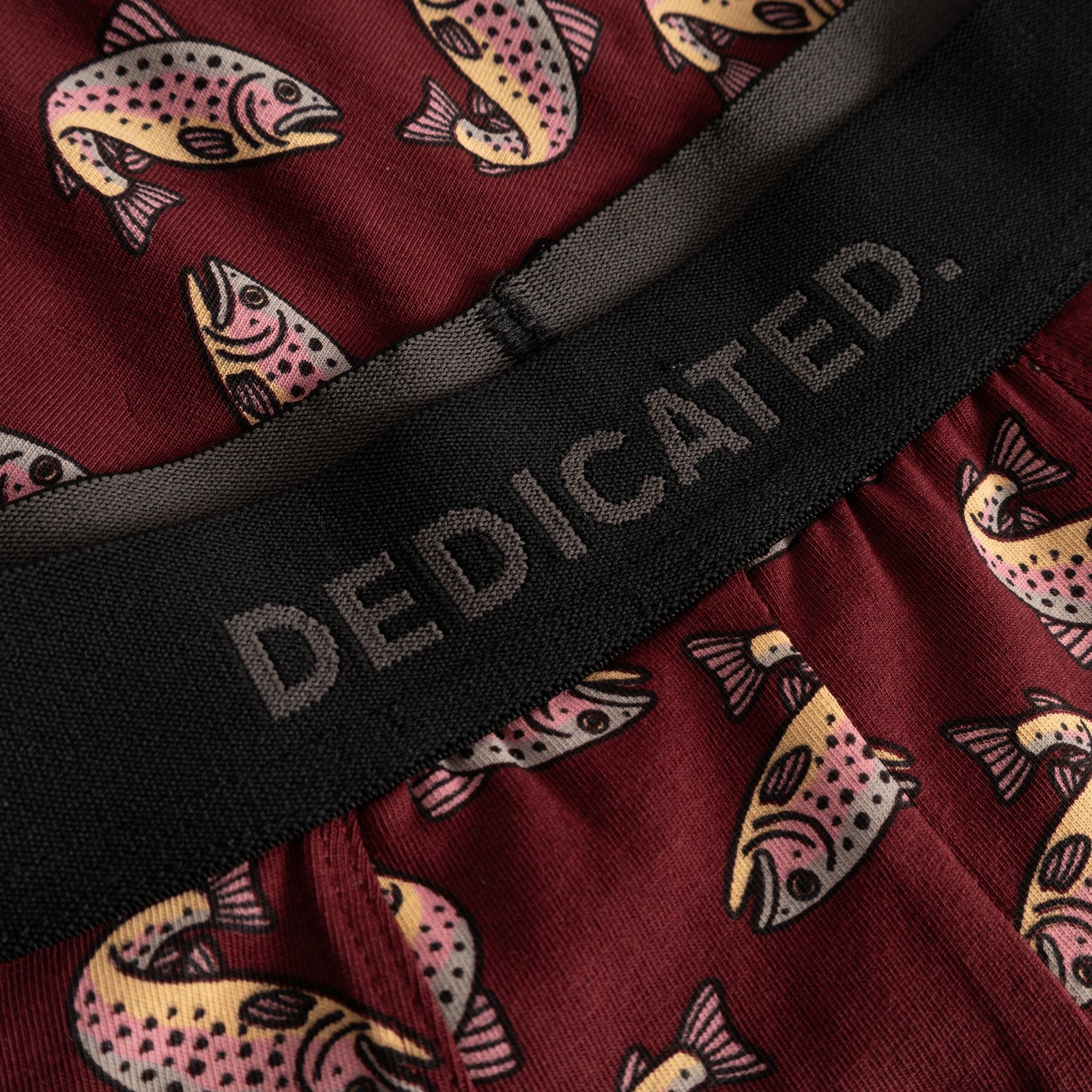Close-up detail of the Dedicated Boxer Briefs Kalix in burgundy, featuring a playful all-over trout print and logo waistband.