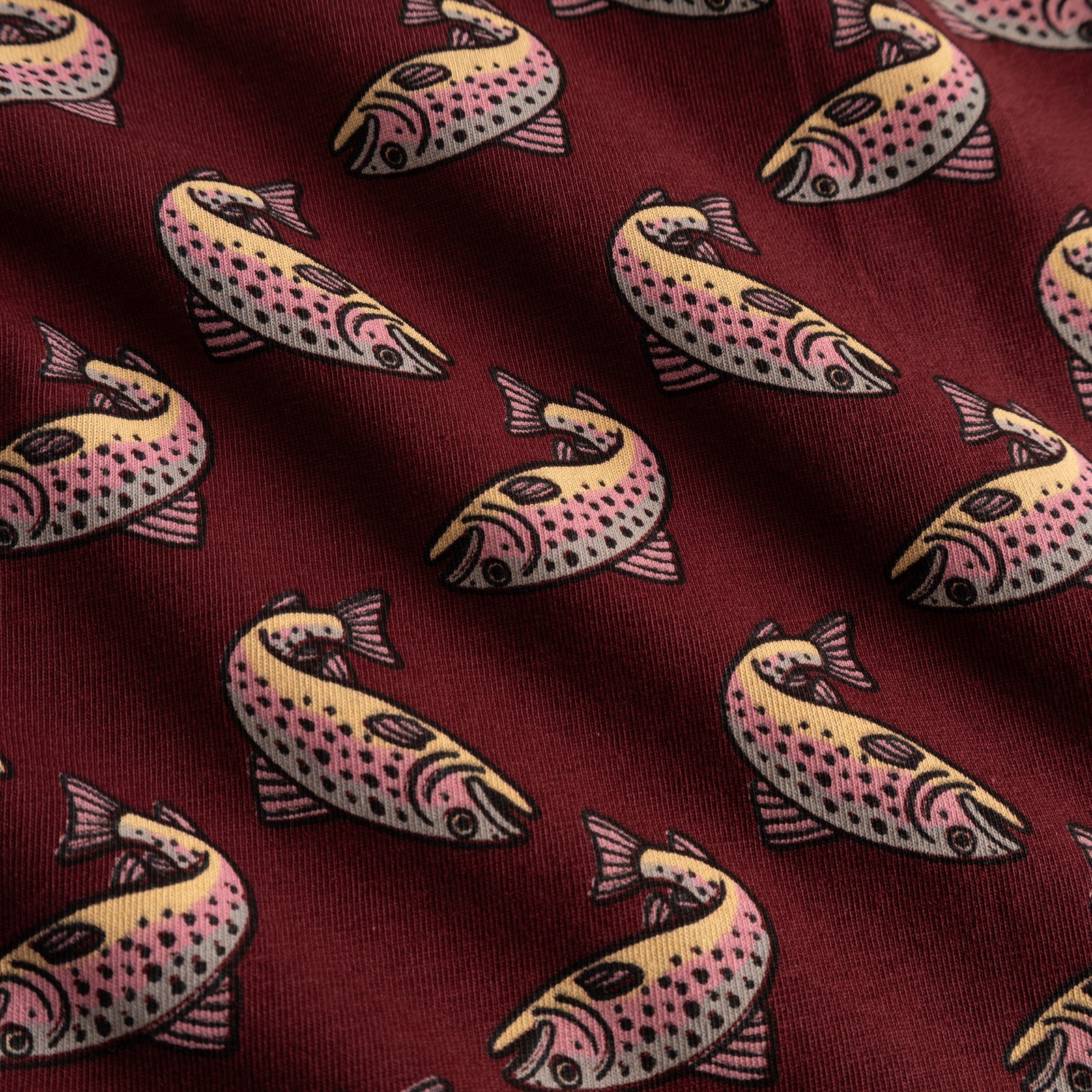 A close-up shot of the burgundy fabric used for the Kalix boxer briefs, showcasing the all-over trout print.