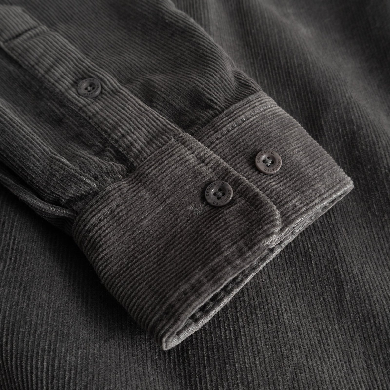 A detailed look at the textured cuff and sleeve of the Varberg Corduroy Shirt in a classic Rock Grey color.