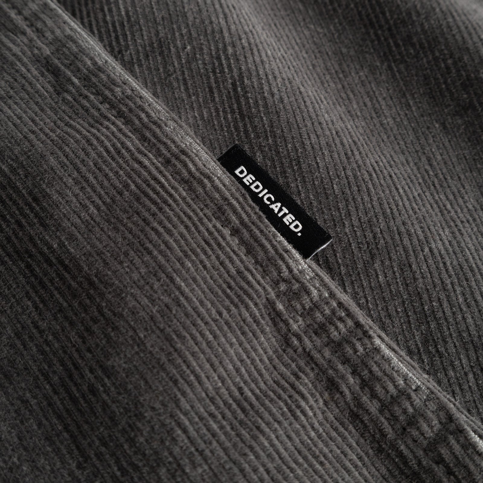 A close-up of the Shirt Varberg Corduroy in Rock Grey, showing the fabric's soft texture and the stitched Dedicated label.