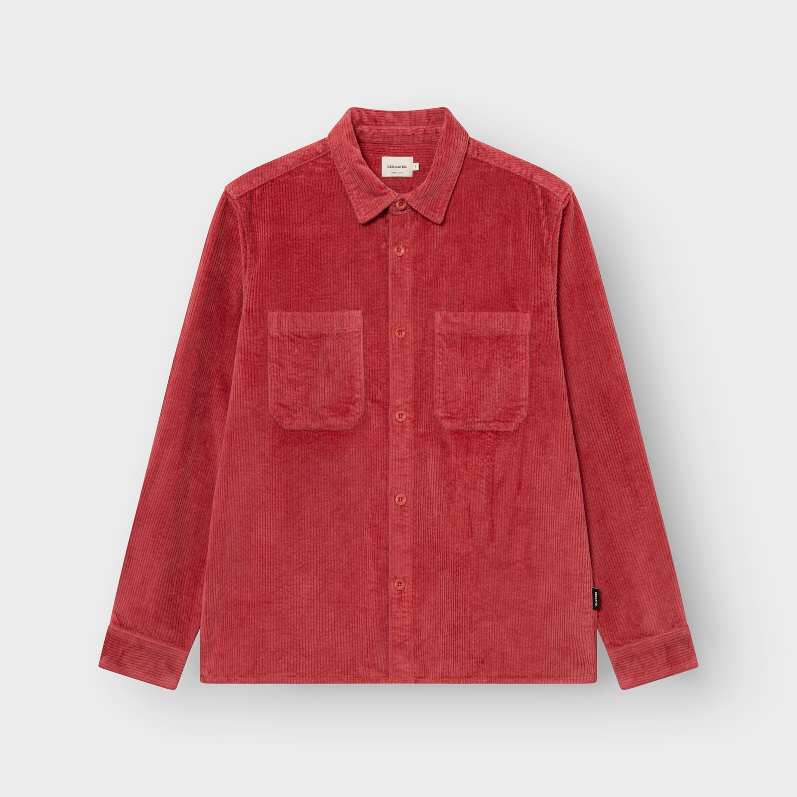 The Kil Corduroy Overshirt in Holly Red, shot flat to highlight its rich texture, dual chest pockets and relaxed fit.