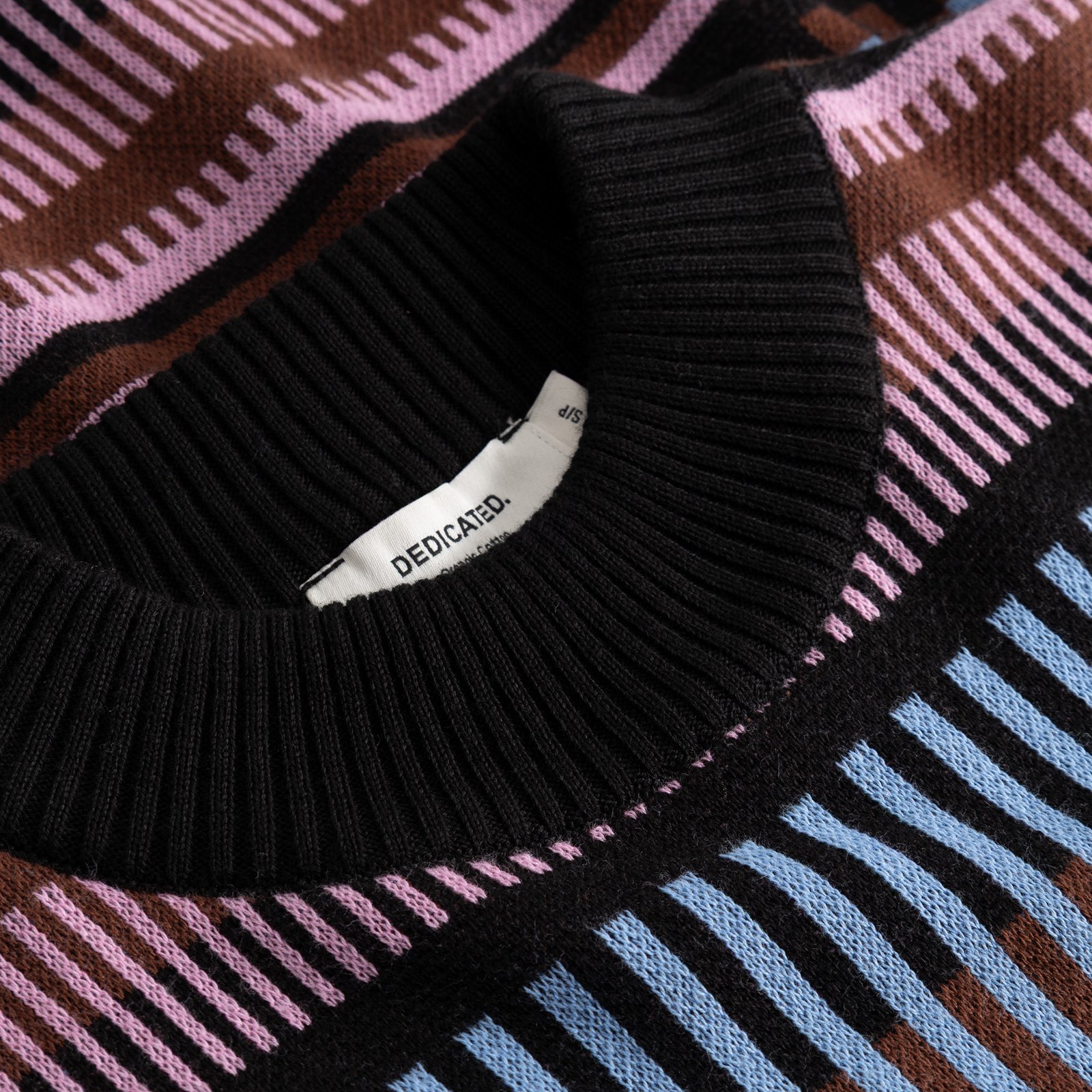 Close-up of the ribbed collar and multi-color dashed stripe pattern on the Sweater Limhamn.