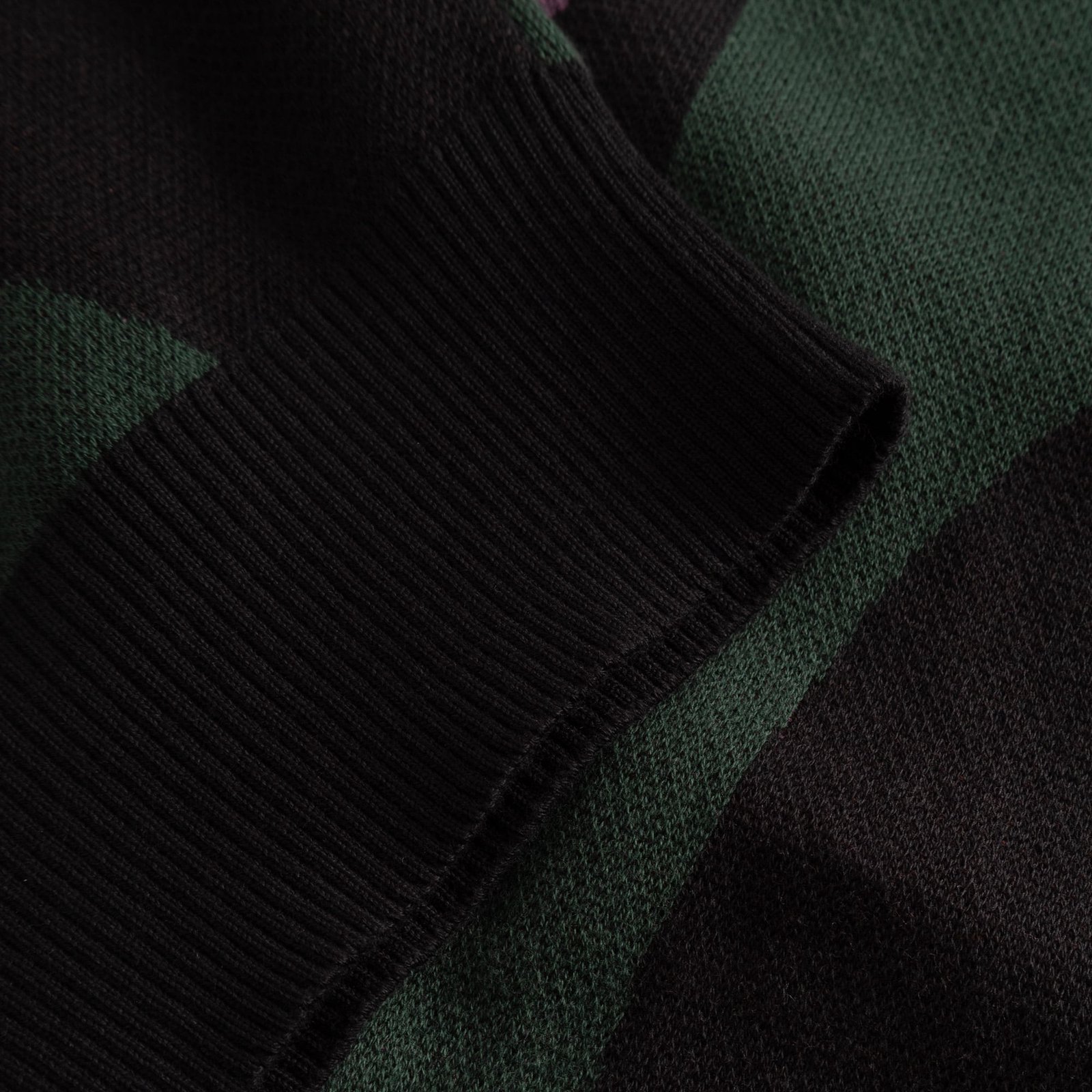 A close-up of the cozy, black ribbed cuff on the Cardigan Kanan Wavy Stripe Multi Color.