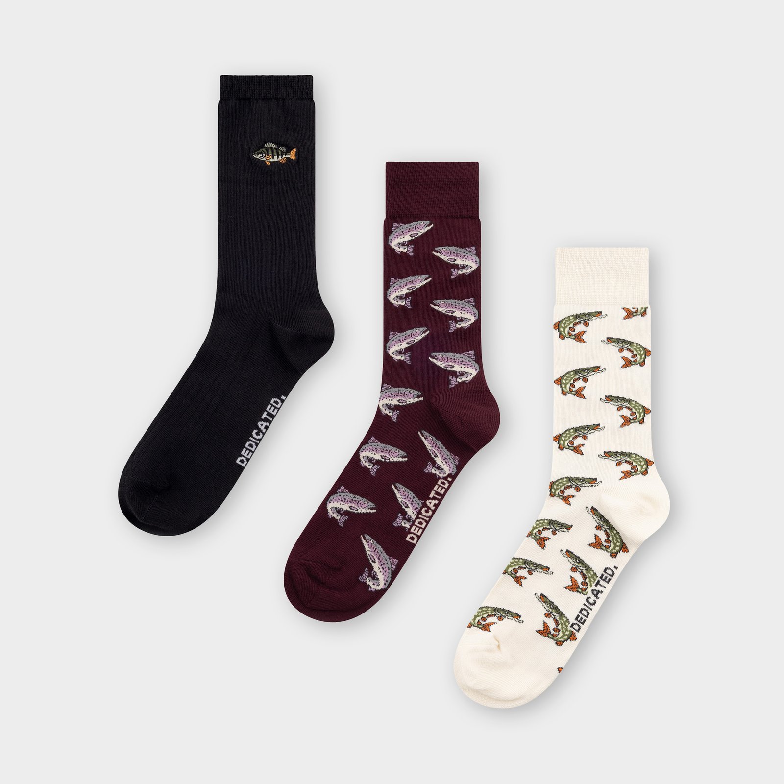 Three pairs of socks from the Fish 3-pack in black, burgundy, and off-white, each with a different fun fish-themed design.