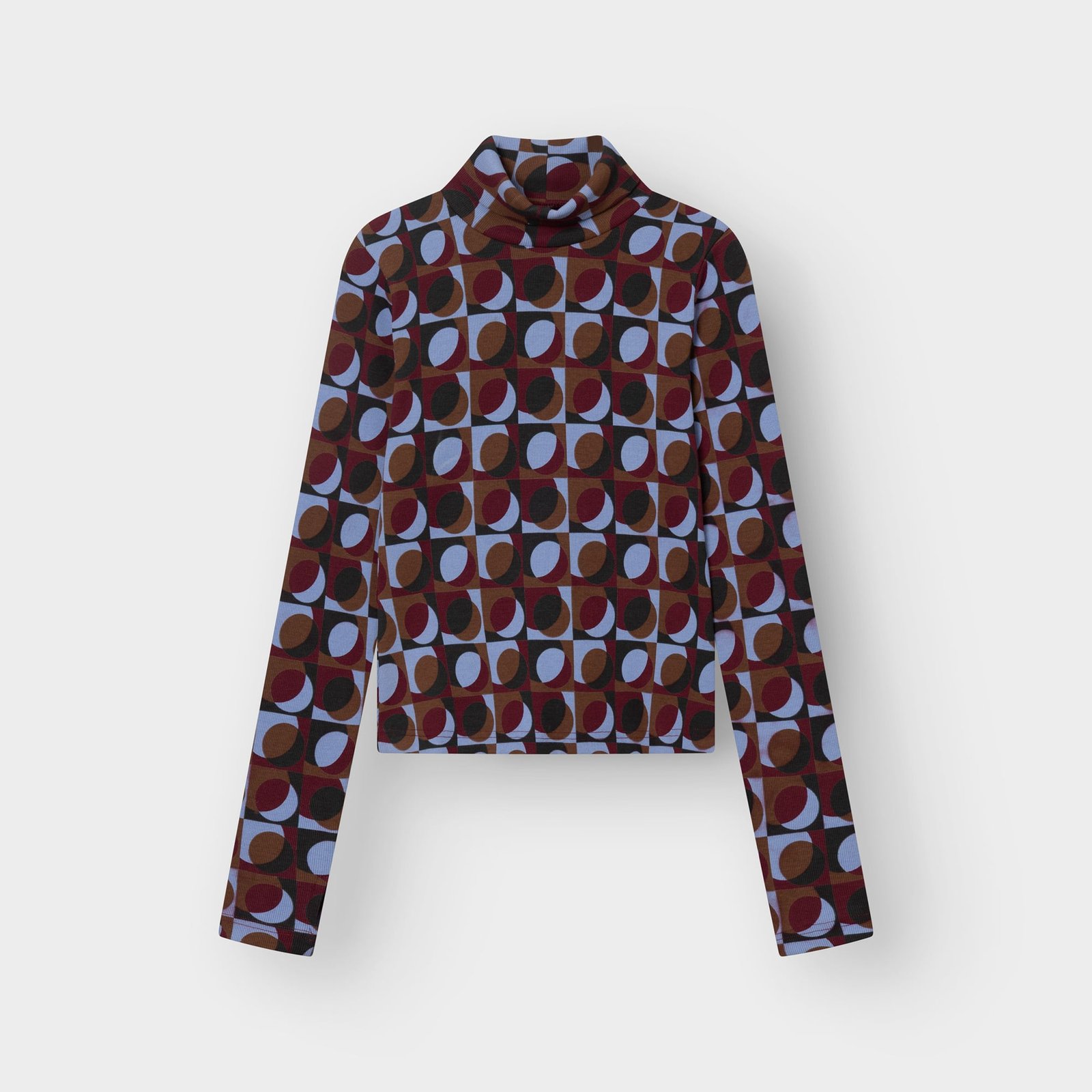 A flat lay product shot of the Rib Top Malma, a turtleneck with a vibrant retro geometric print in multiple colors.