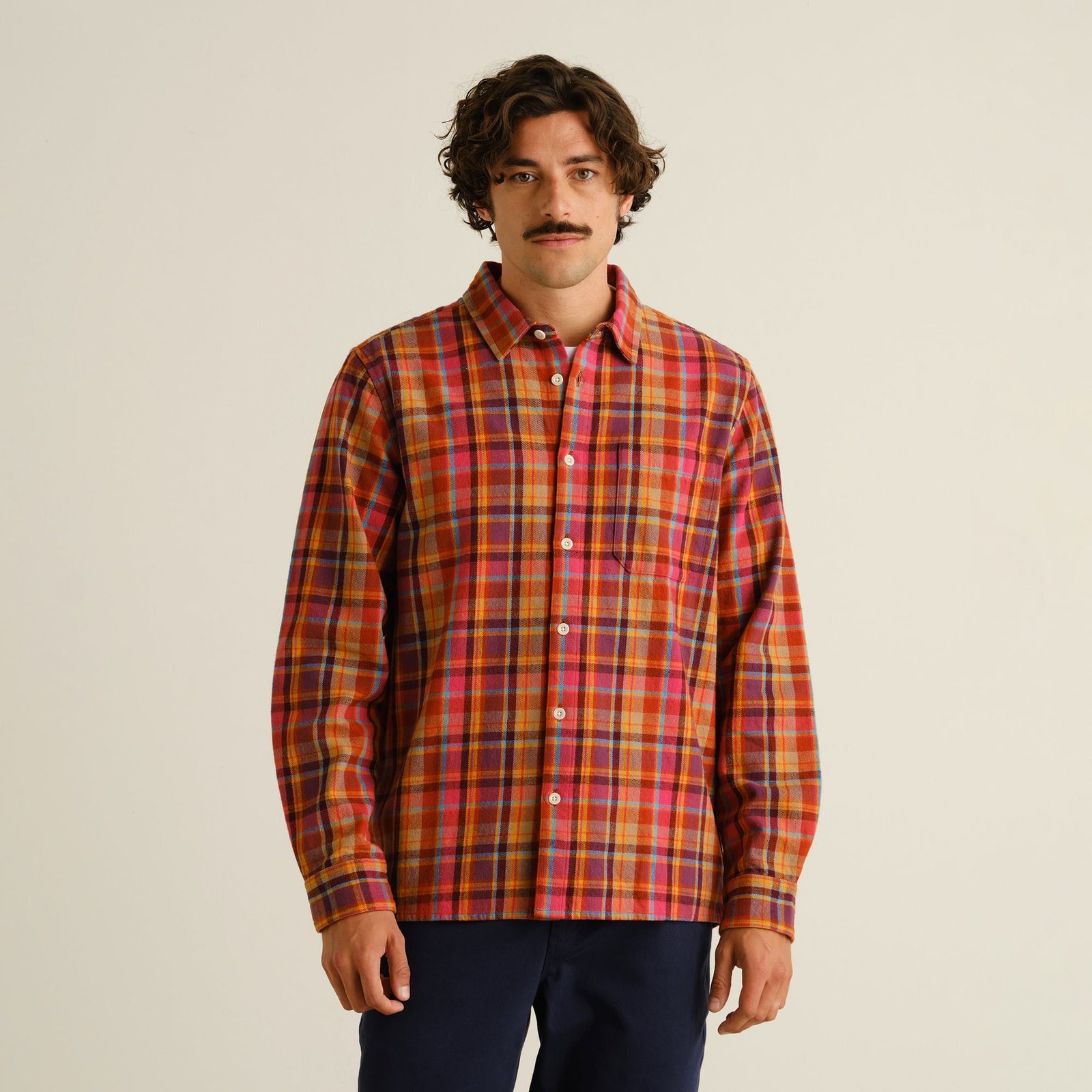 Front view of a model wearing the Rute Flannel Shirt in a vibrant Madras Check Multi Color pattern.