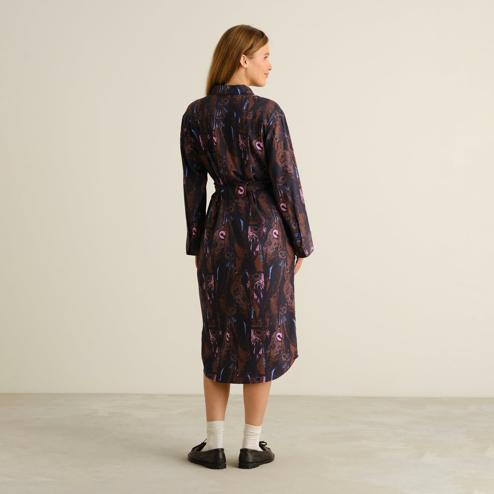 Back view of the Kvilla Shirt Dress in a whimsical owl print, showing off its elegant drape and belted waist.