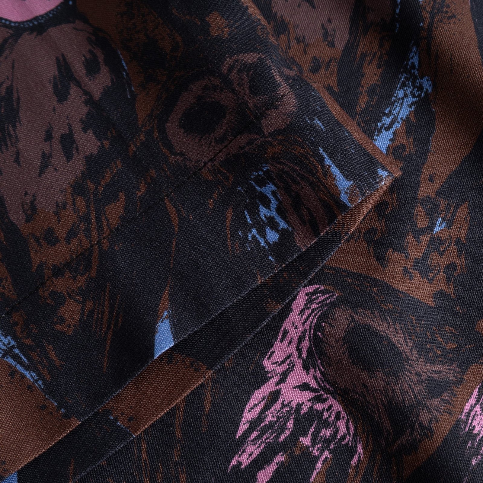 A detailed look at the sleeve of the Top Udda Owls top, showcasing the rich texture and the playful, artistic owl pattern.