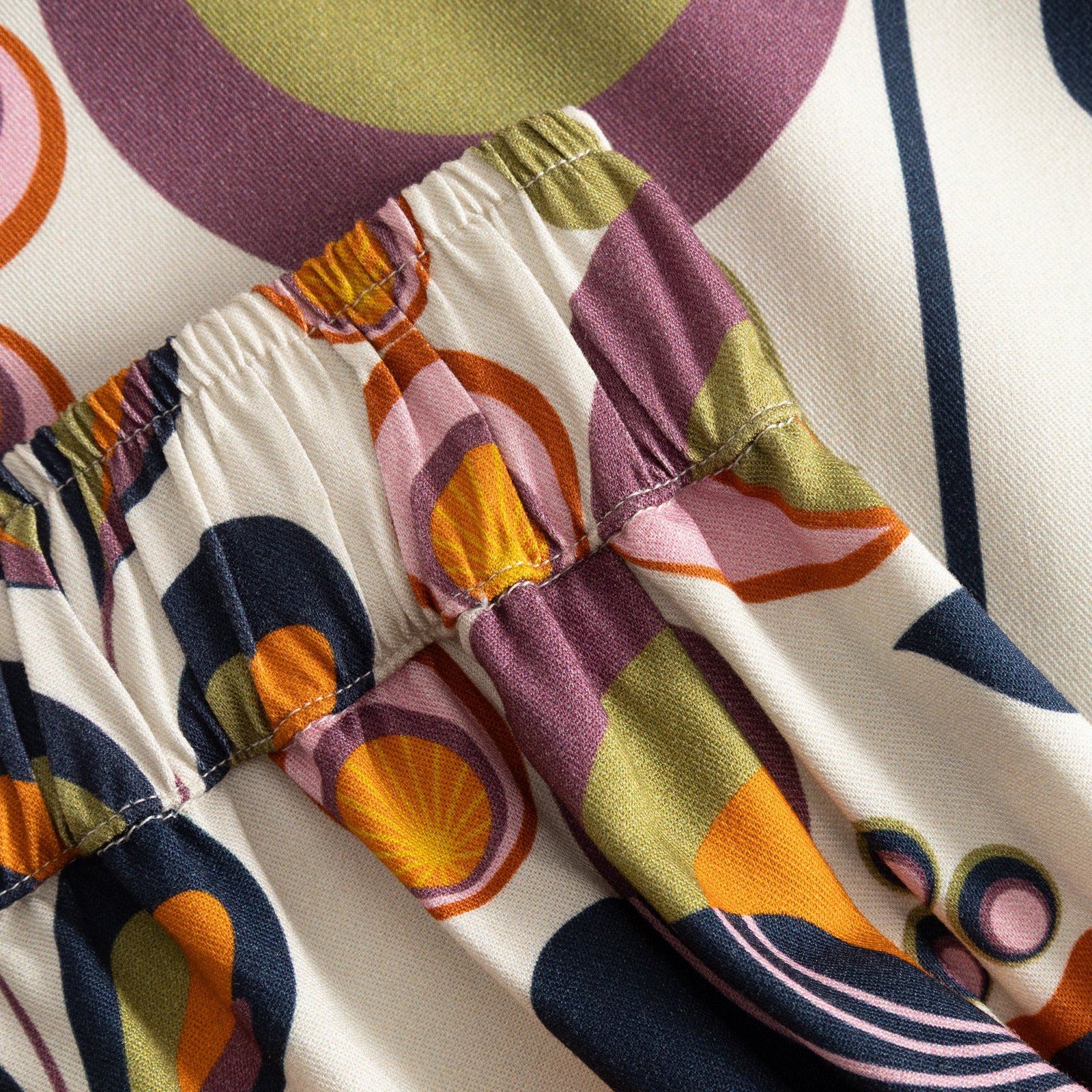 Close-up detail of the elastic waistband on the Skirt Viken, showing the colorful Autumn Harvest print.