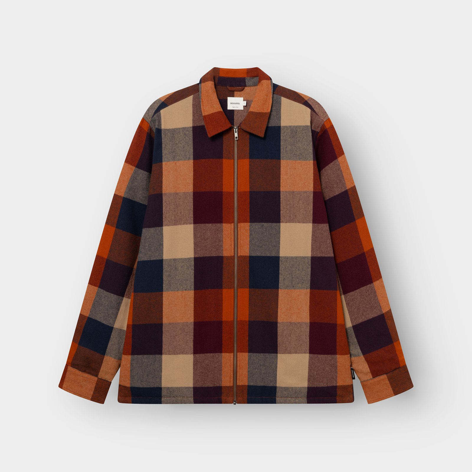 Studio shot of the Torp Flannel Jacket in a muted multi-color check, laid flat against a light grey background.