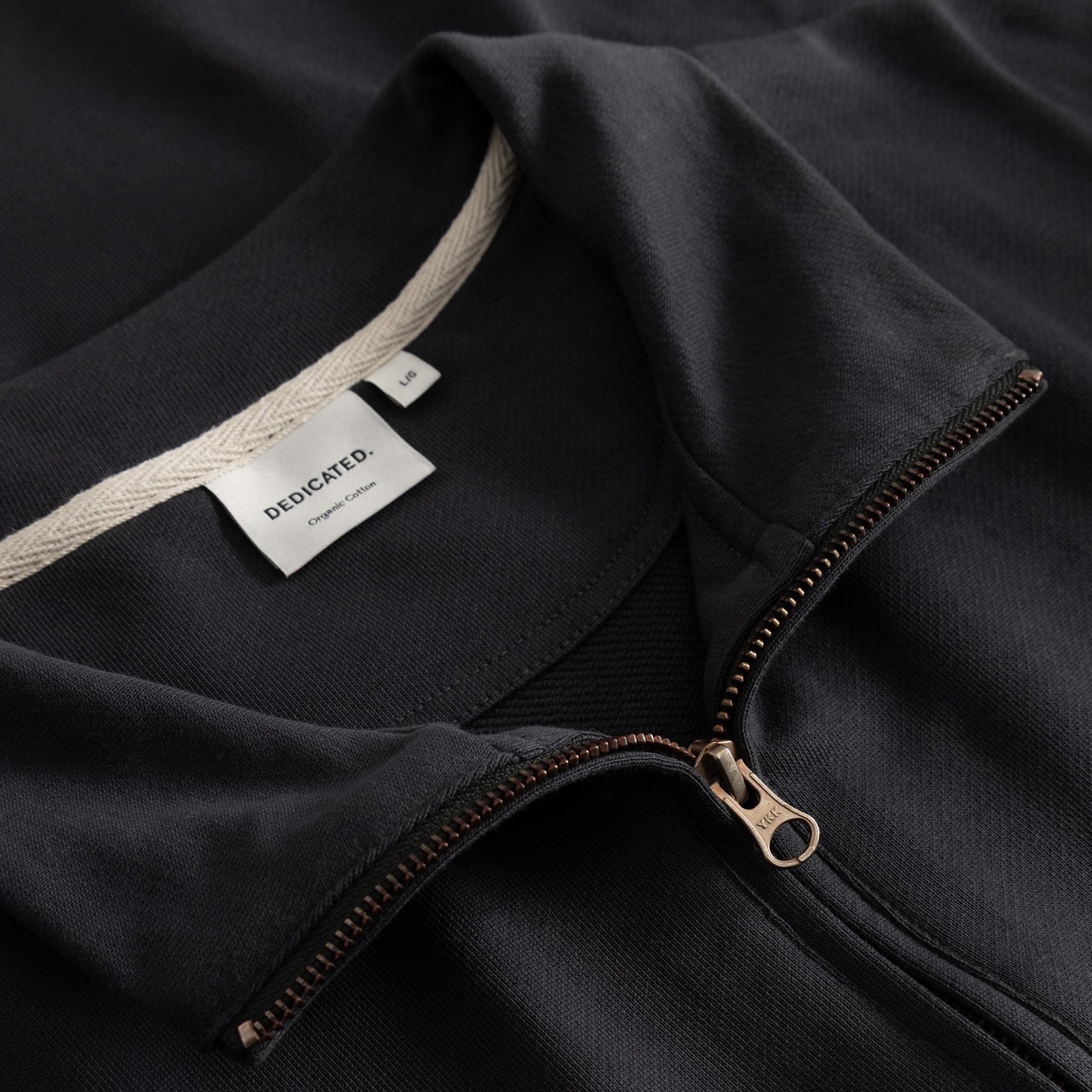 A close-up view of the Half Zip Sweatshirt Sandvalla in Phantom Black, highlighting the collar, metal zip, and brand label.
