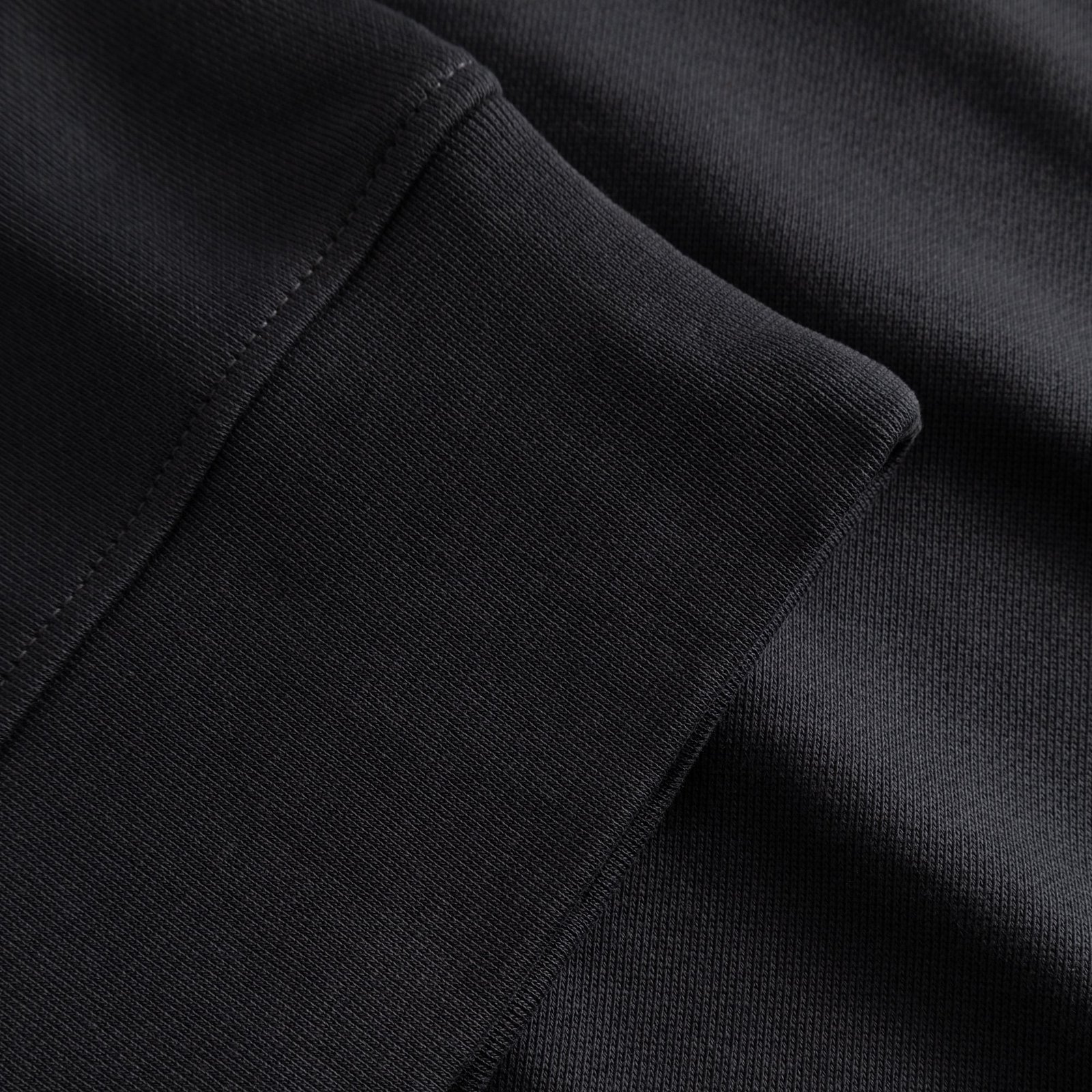 Close-up of the ribbed cuff and heavy cotton fabric of the Sandvalla Half Zip Sweatshirt in Phantom Black.