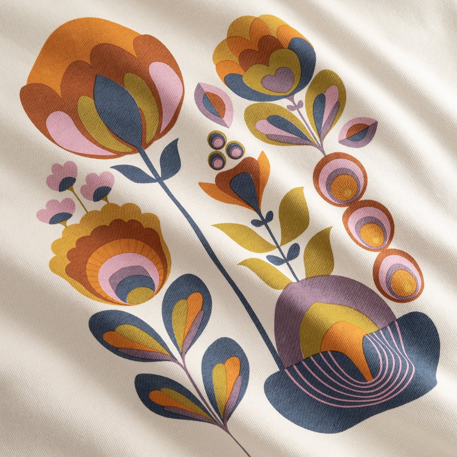 Close-up of the Ystad Sweatshirt in Oat White, showcasing the colorful, retro-inspired Autumn Harvest floral print.